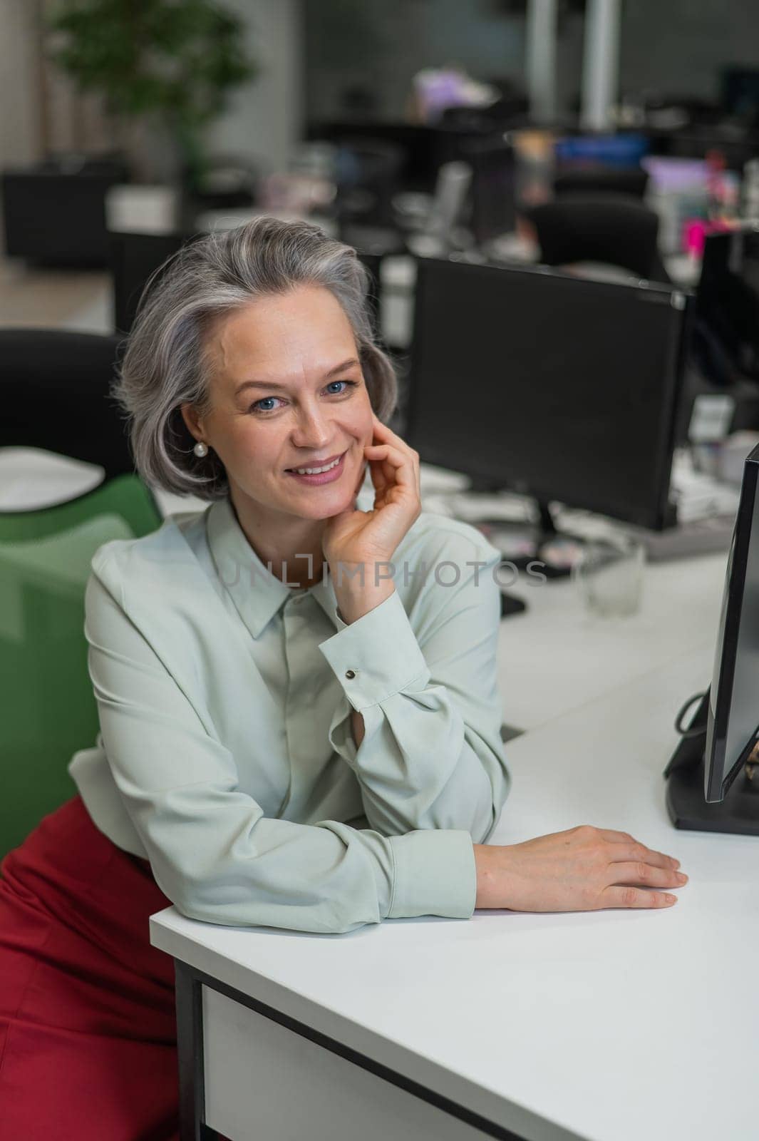 Mature caucasian woman at the desk in the office. by mrwed54