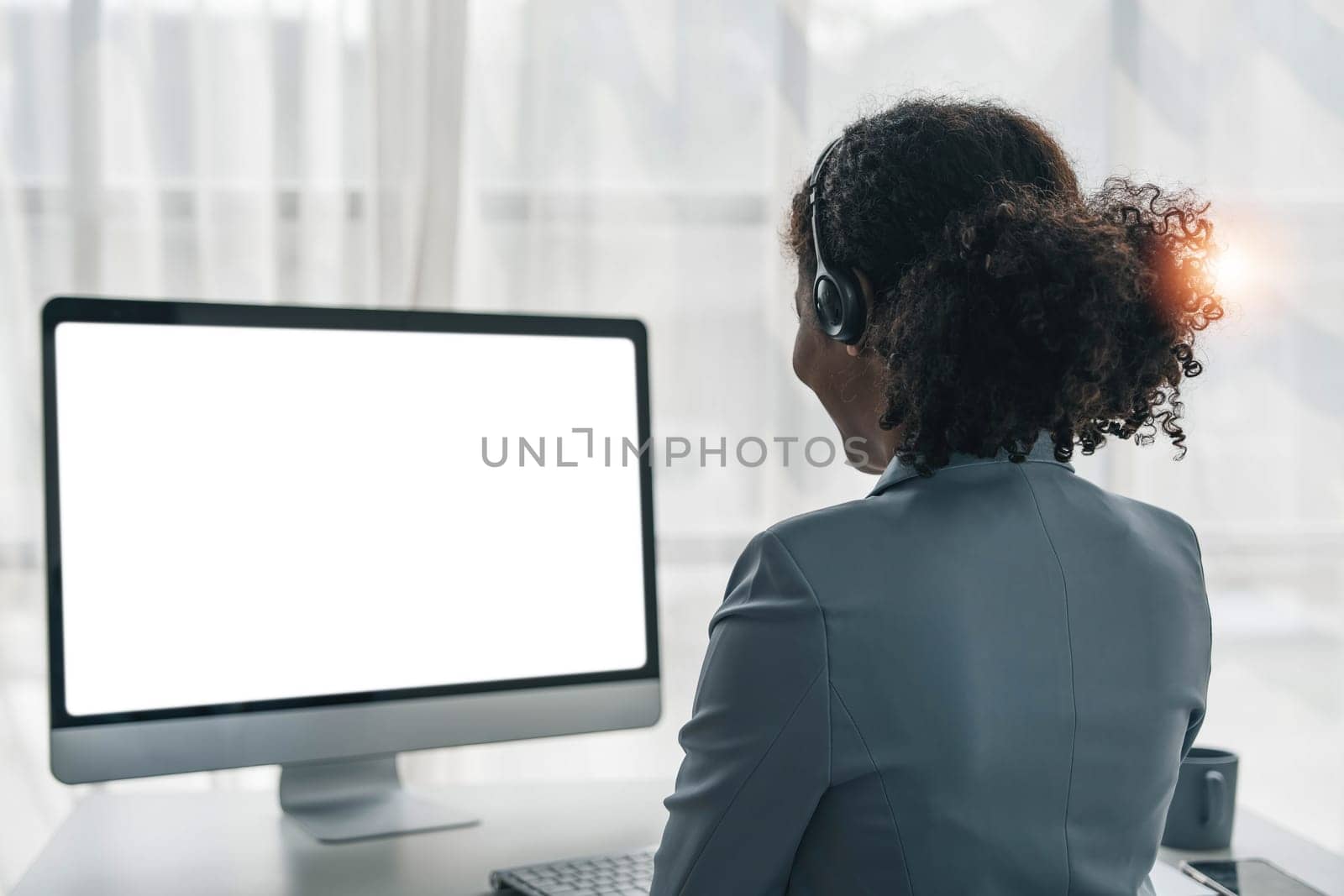 close up call center operator in wireless headset talking with customer, woman in headphones with microphone consulting client on phone in customer support service, looking at computer screen..