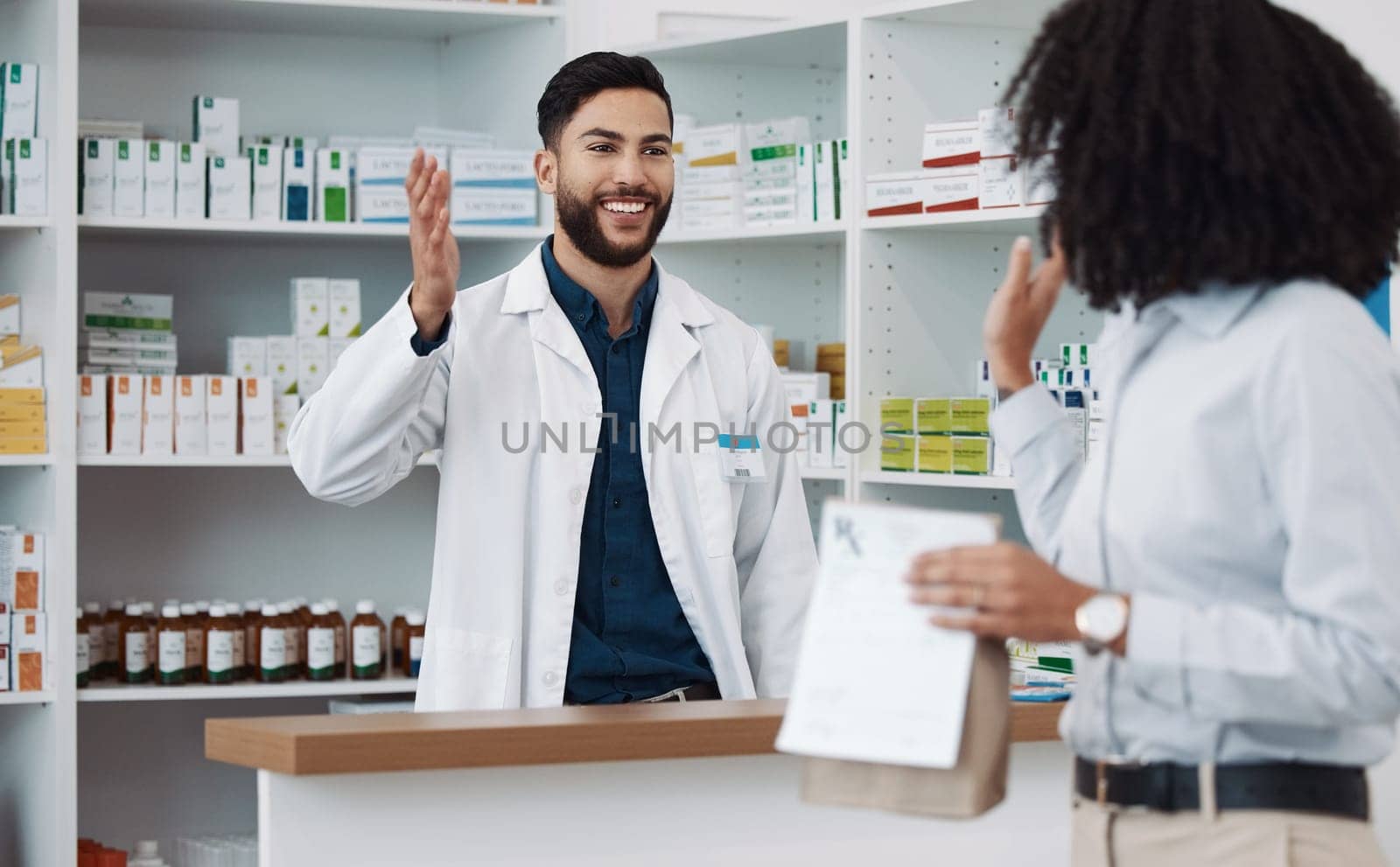 Customer service, counter and pharmacist man with medicine, expert advice or healthcare support. Happy doctor, medical professional or friendly retail person in pharmacy talking to woman at help desk.