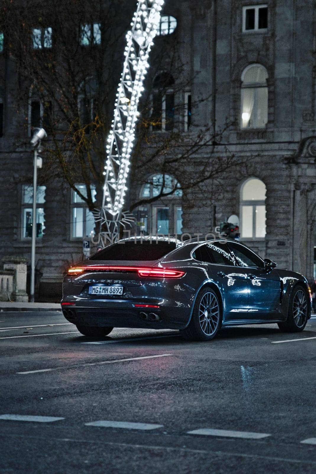 A black Porsche Panamera stands under an arc on Koenigsallee in Duesseldorf, Germany