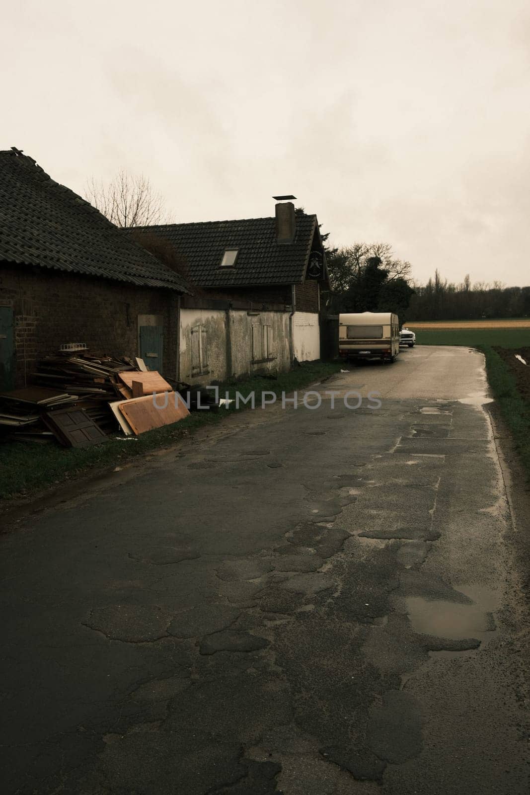 Caravan in front of run-down house on a side road near Meerbusch, Germany