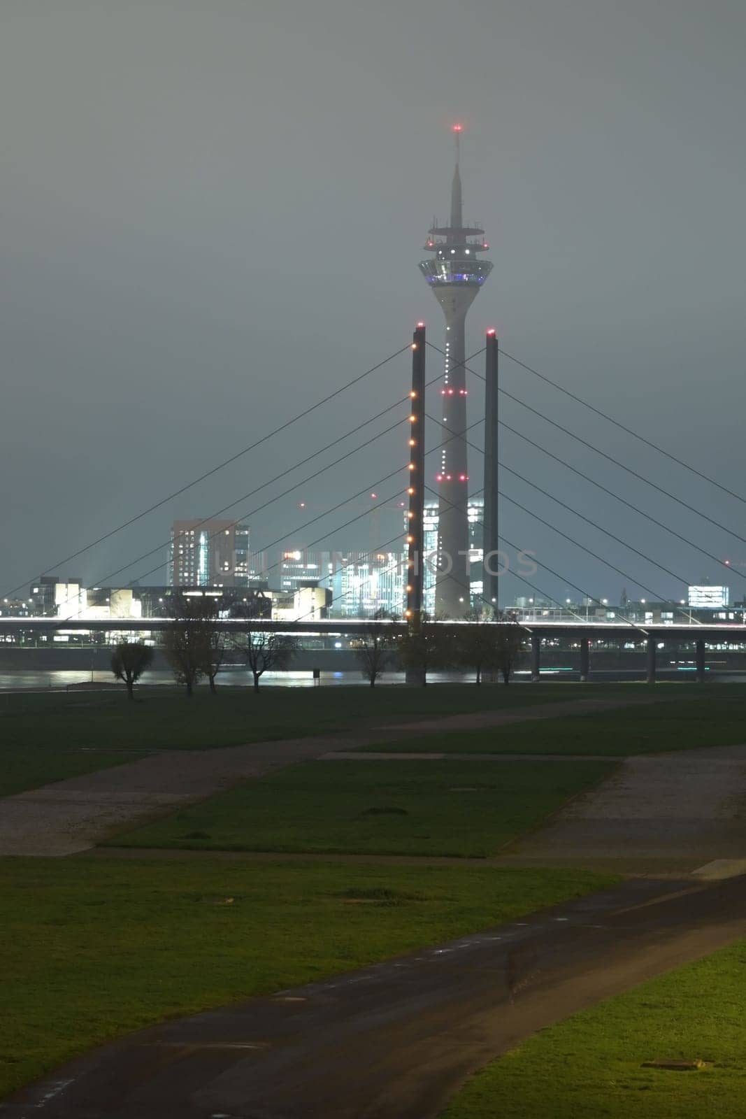 Tower and Theodor Heuss bridge at night and fog in Dusseldorf, Germany