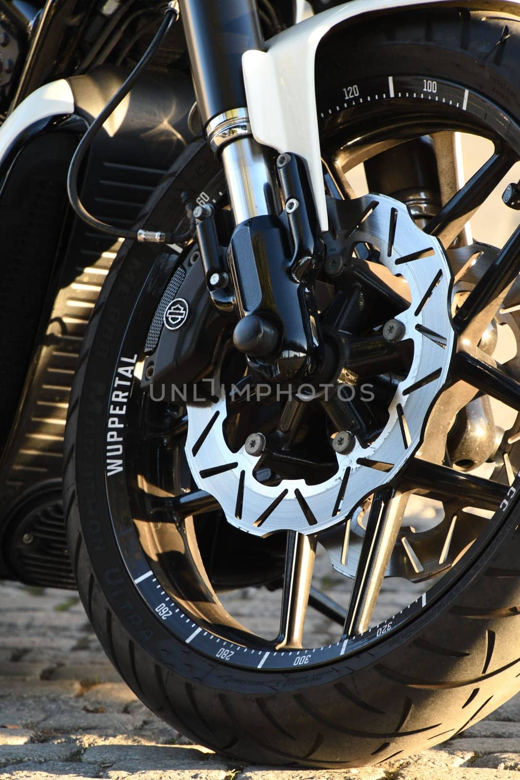 Vertical closeup of a front wheel of a chopper motorcycle