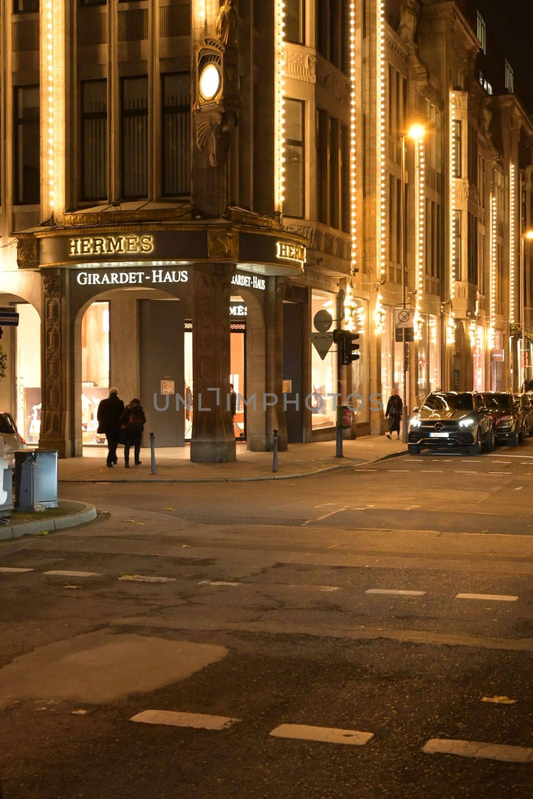 Girardet house with Hermes sign on the Koe in and cars parked on the street