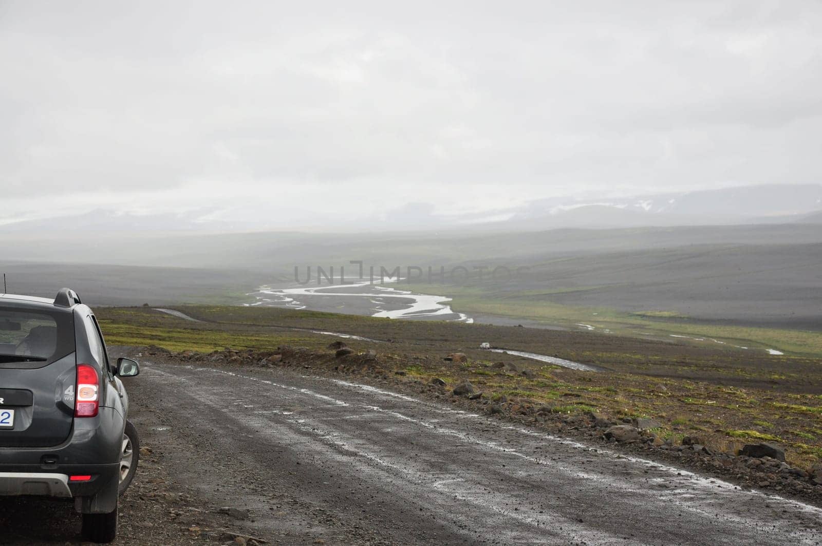 Gray SUV on a gravel road in Iceland