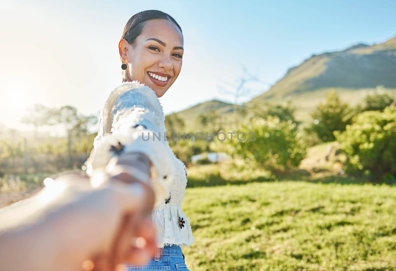 Woman, park portrait and pov for holding hands, romance and love on nature adventure in sunshine. Girl, summer and outdoor in countryside with smile, happy and bonding by trees, grass and mountain.