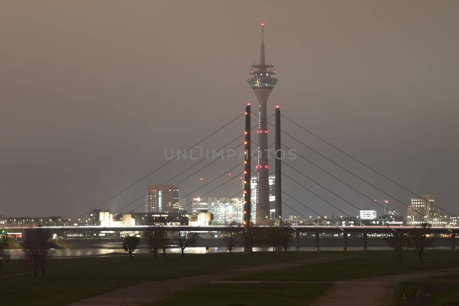 Tower and Theodor Heuss bridge at night and fog in Dusseldorf, Germany