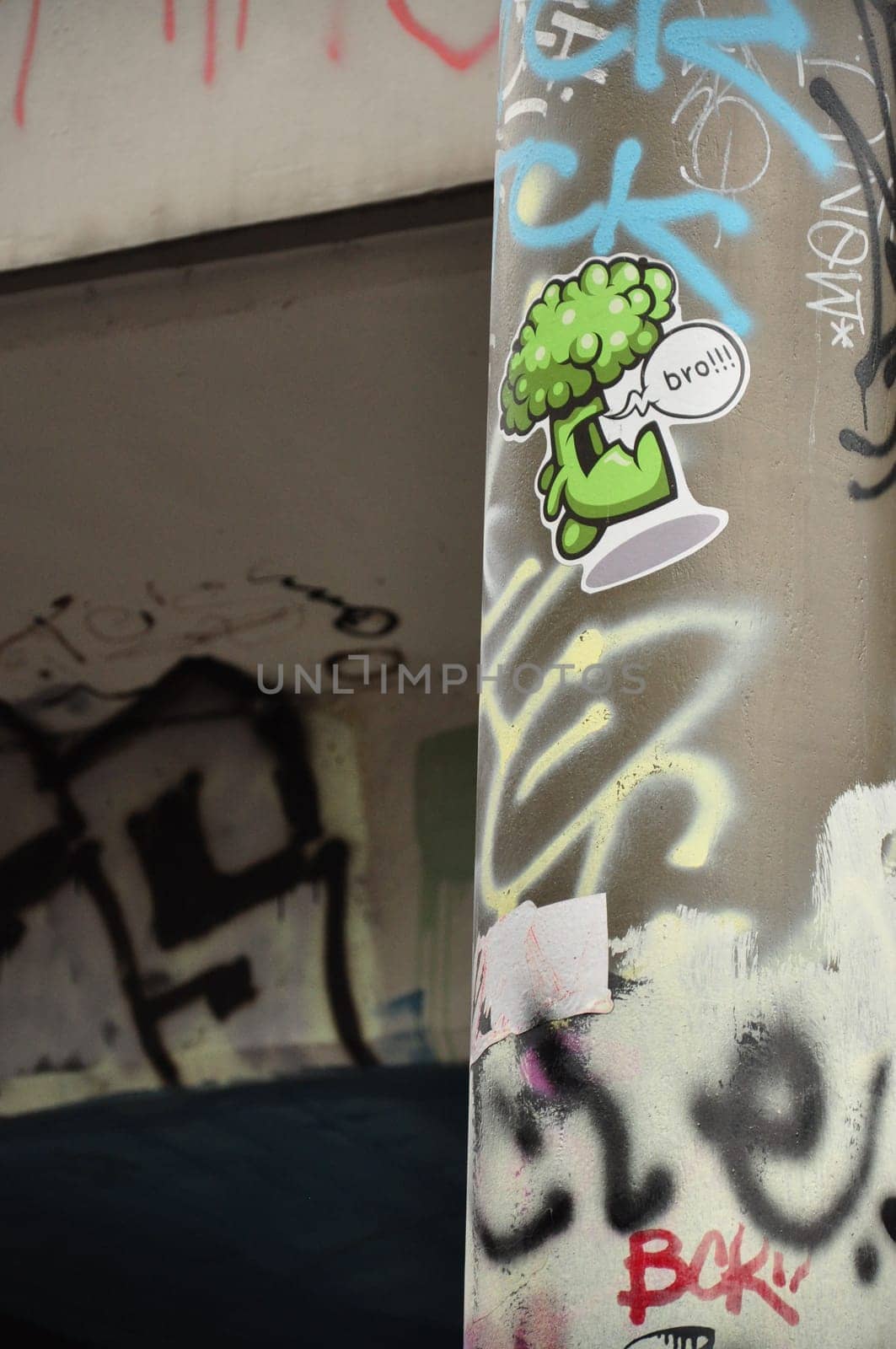 Vertical closeup shot of a graffiti and sticker on lanternon Tesnov Street in Prague, Czech Republic