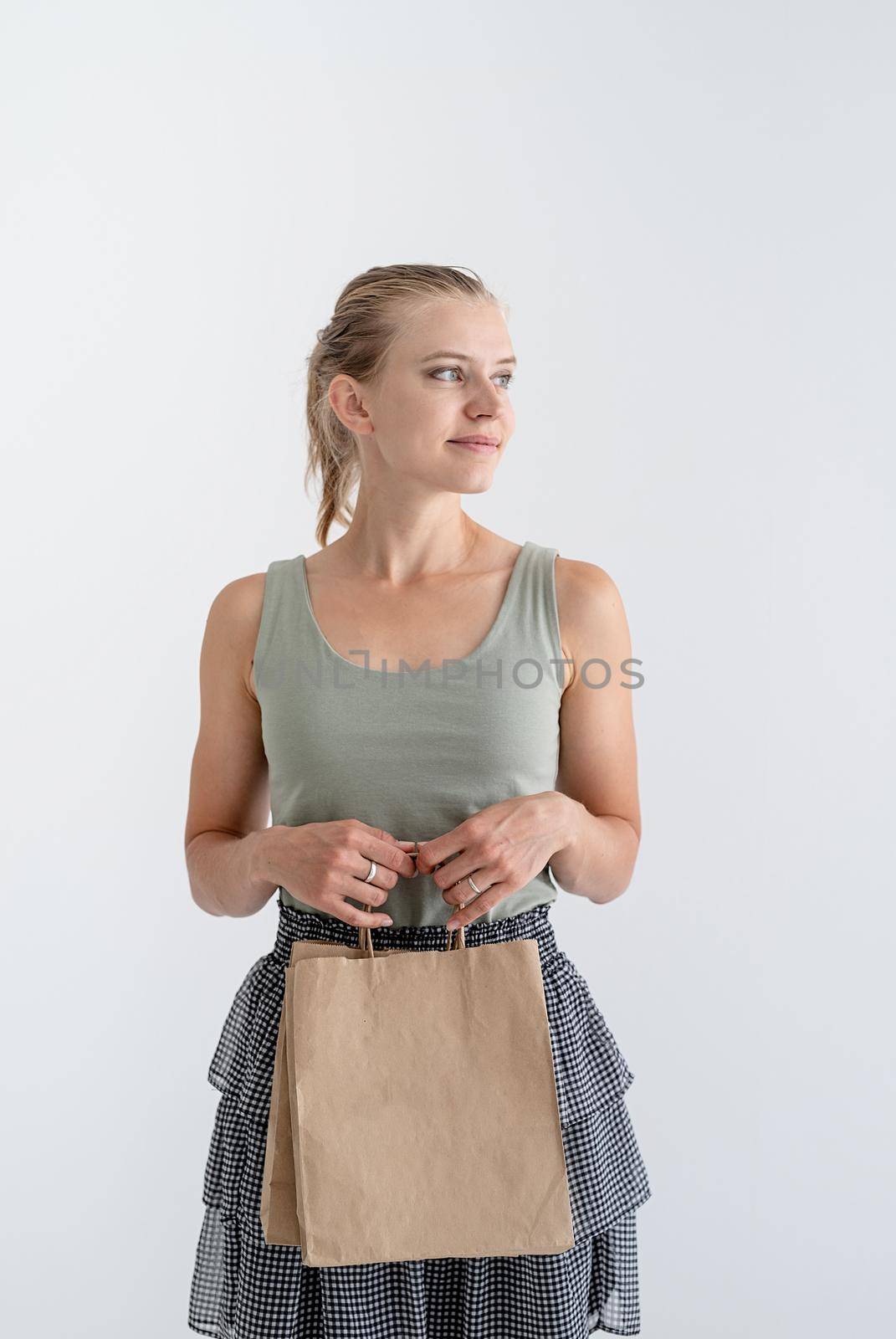 Online shopping concept. Young smiling woman holding eco friendly shopping bags