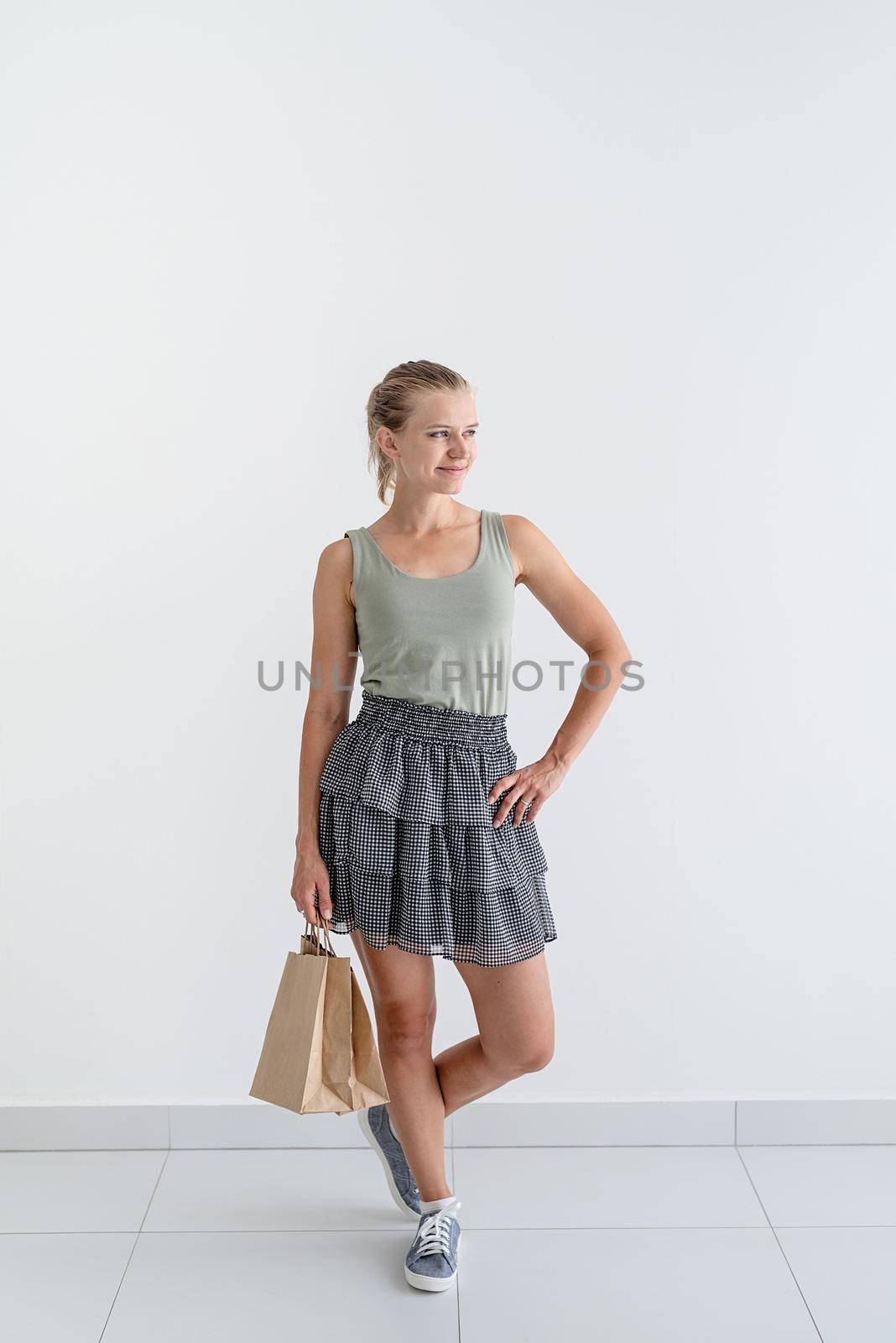 Online shopping concept. Young smiling woman holding eco friendly shopping bags