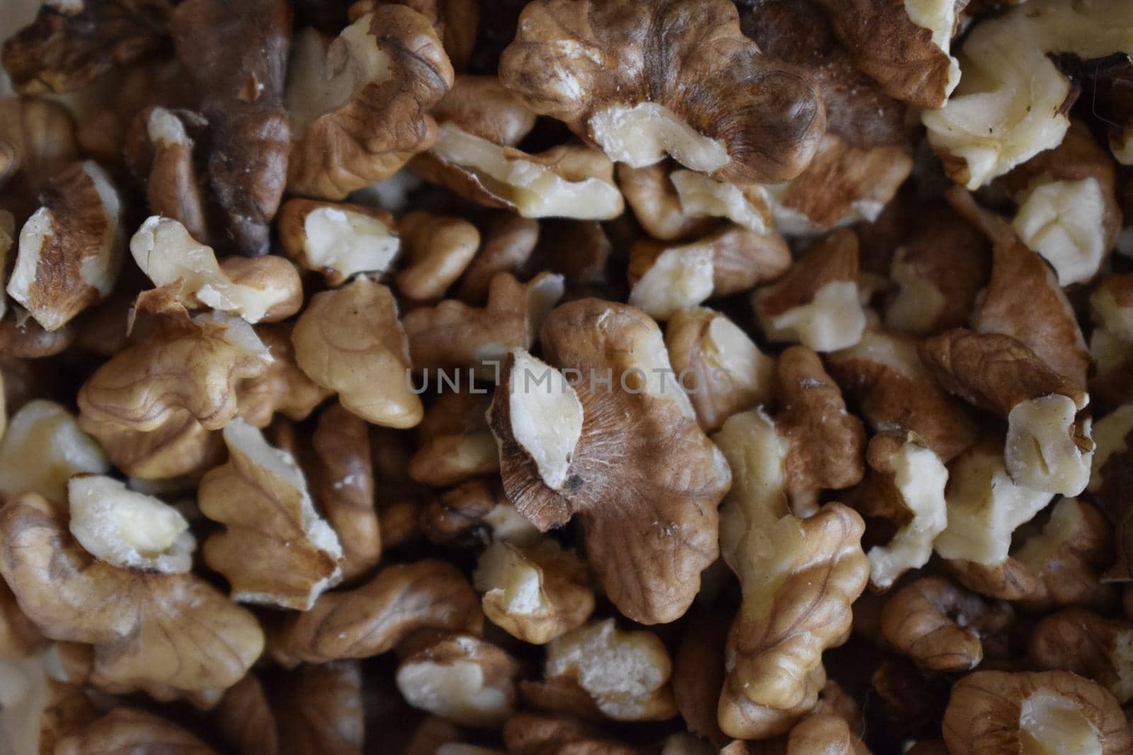 Closeup of big shelled walnuts pile. Big shelled walnuts background