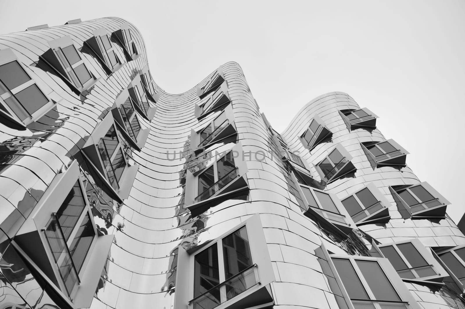 Mirrored metal facade of the Gehry buildings at the Media Harbour in Dusseldorf, Germany