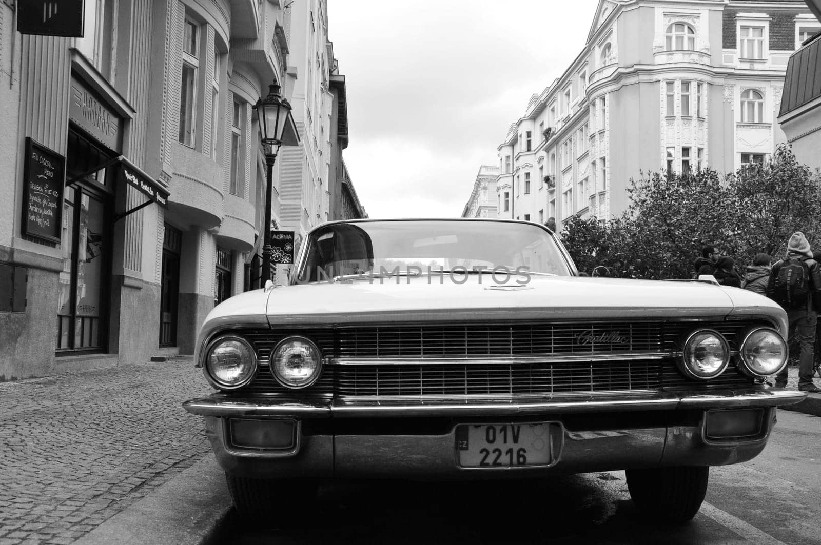 Grayscale of Cadillac in city center of Prague, Czech Republic