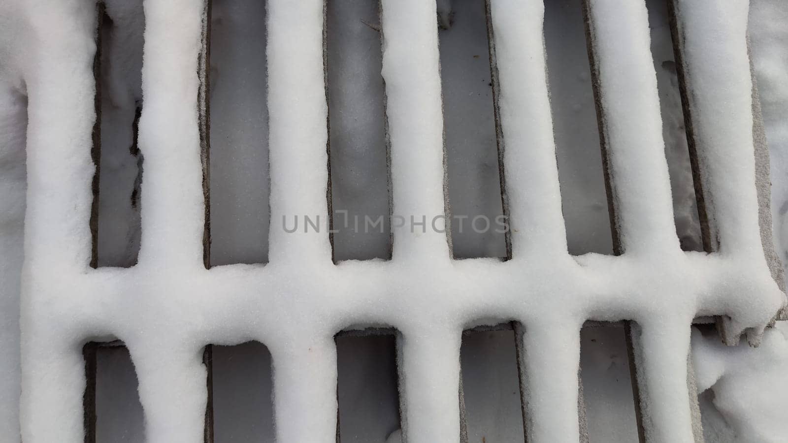 Abstract background and texture in the form of strips of wooden slats covered with white snow