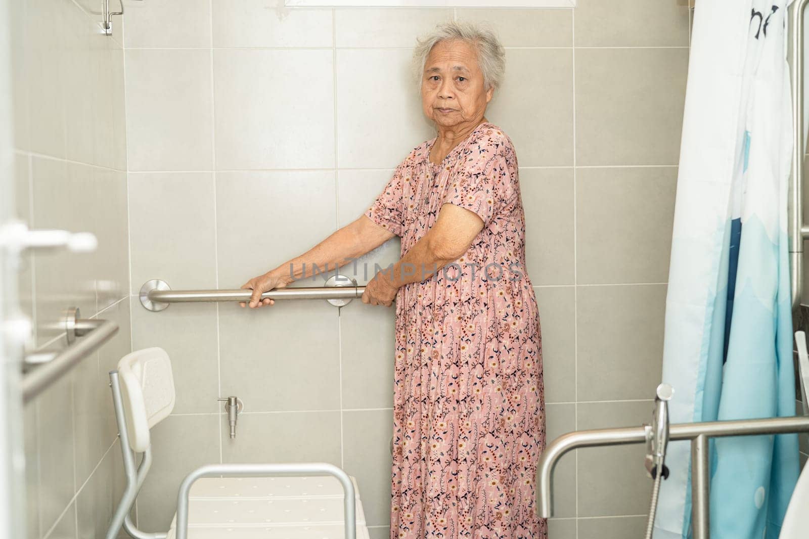 Asian senior or elderly old lady woman patient use toilet bathroom handle security in nursing hospital, healthy strong medical concept.
