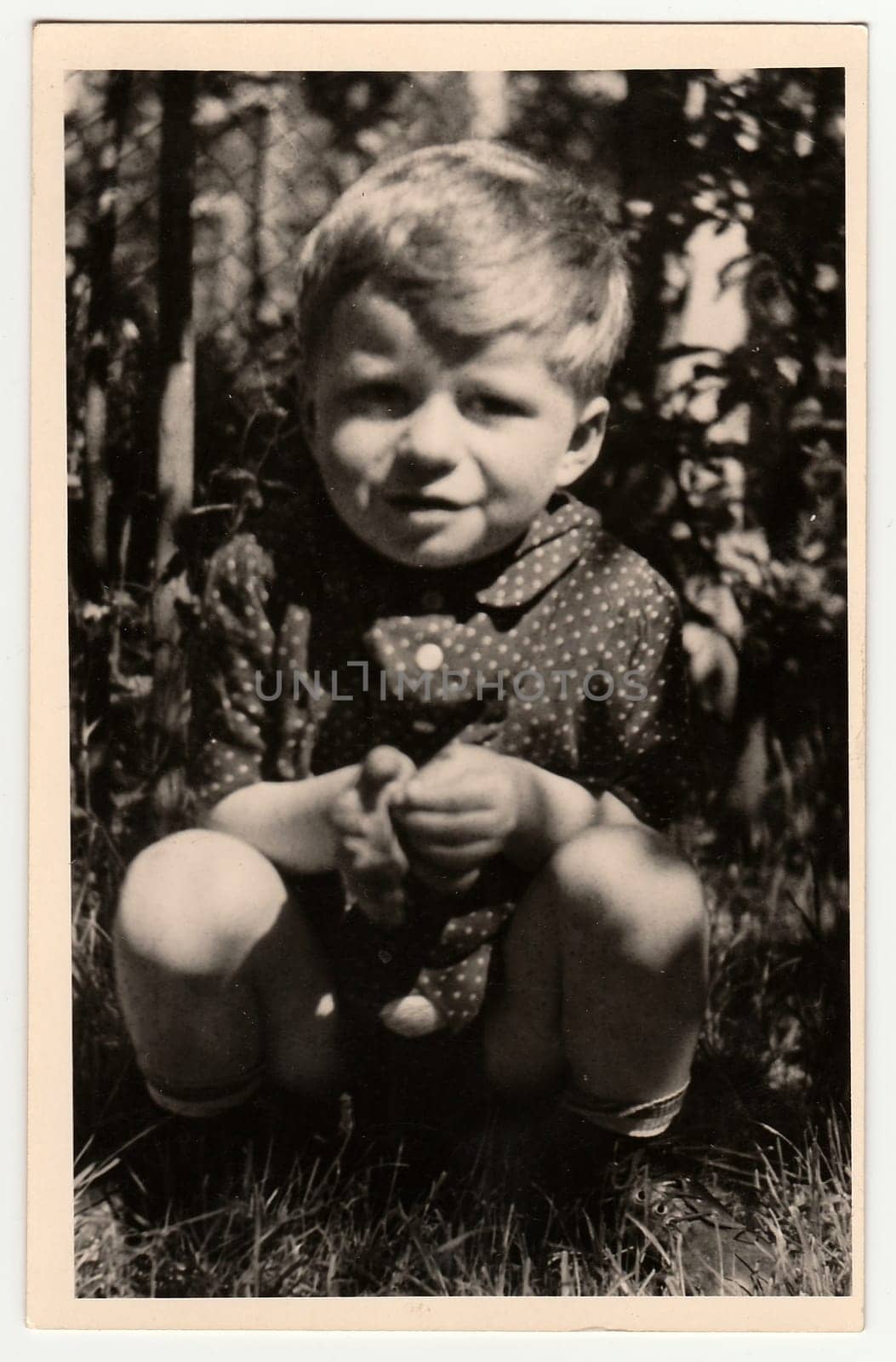 Vintage photo shows a small boy. by roman_nerud