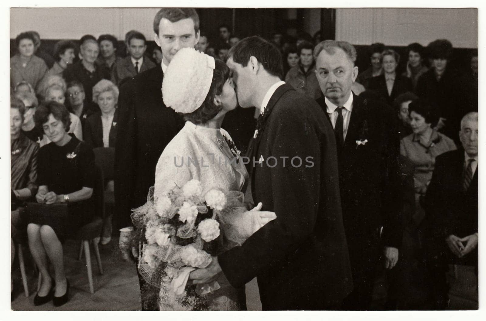 TEPLICE, THE CZECHOSLOVAK SOCIALIST REPUBLIC - OCTOBER 15, 1966: Vintage photo of wedding ceremony - bridal kiss