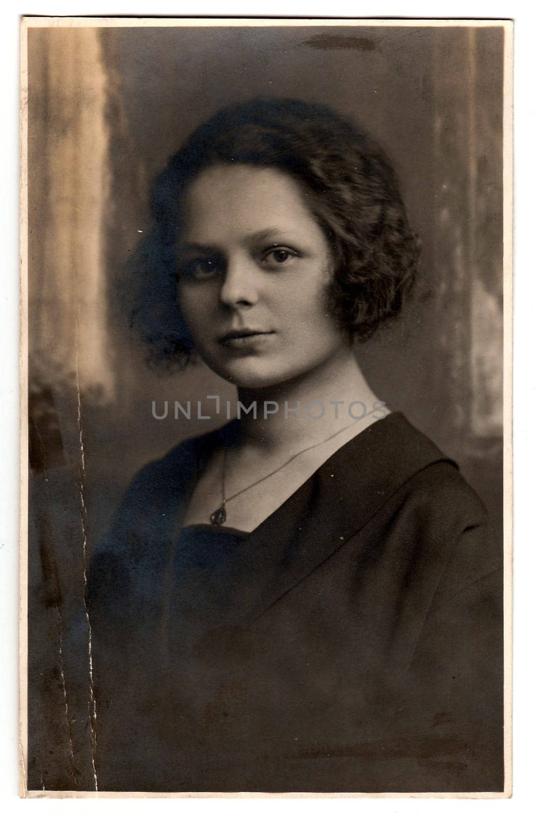 Vintage photo of a young woman with mysterious look by roman_nerud