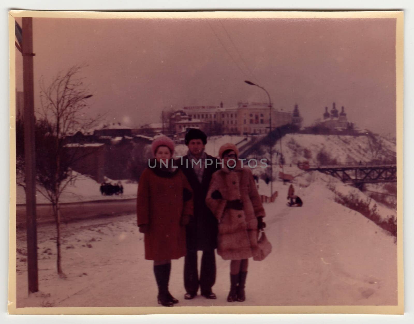 Vintage photo shows people pose on street in winter. by roman_nerud