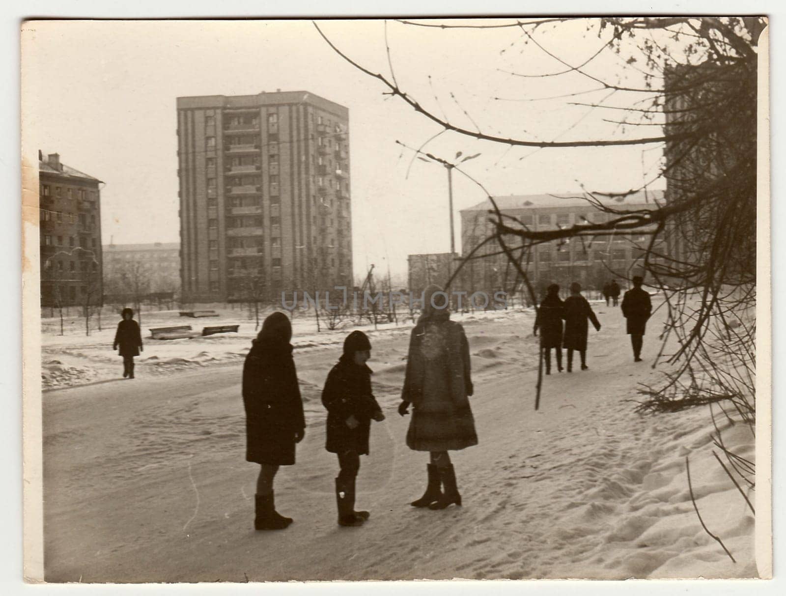 USSR - CIRCA 1980s: Vintage photo shows girls and boy talk on street in winter.