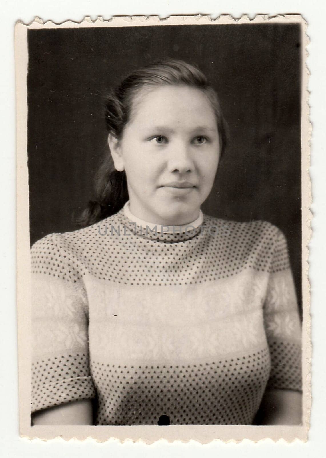 USSR - FEBRUARY 29, 1952: Vintage portrait shows a young woman. Black and white antique photo.