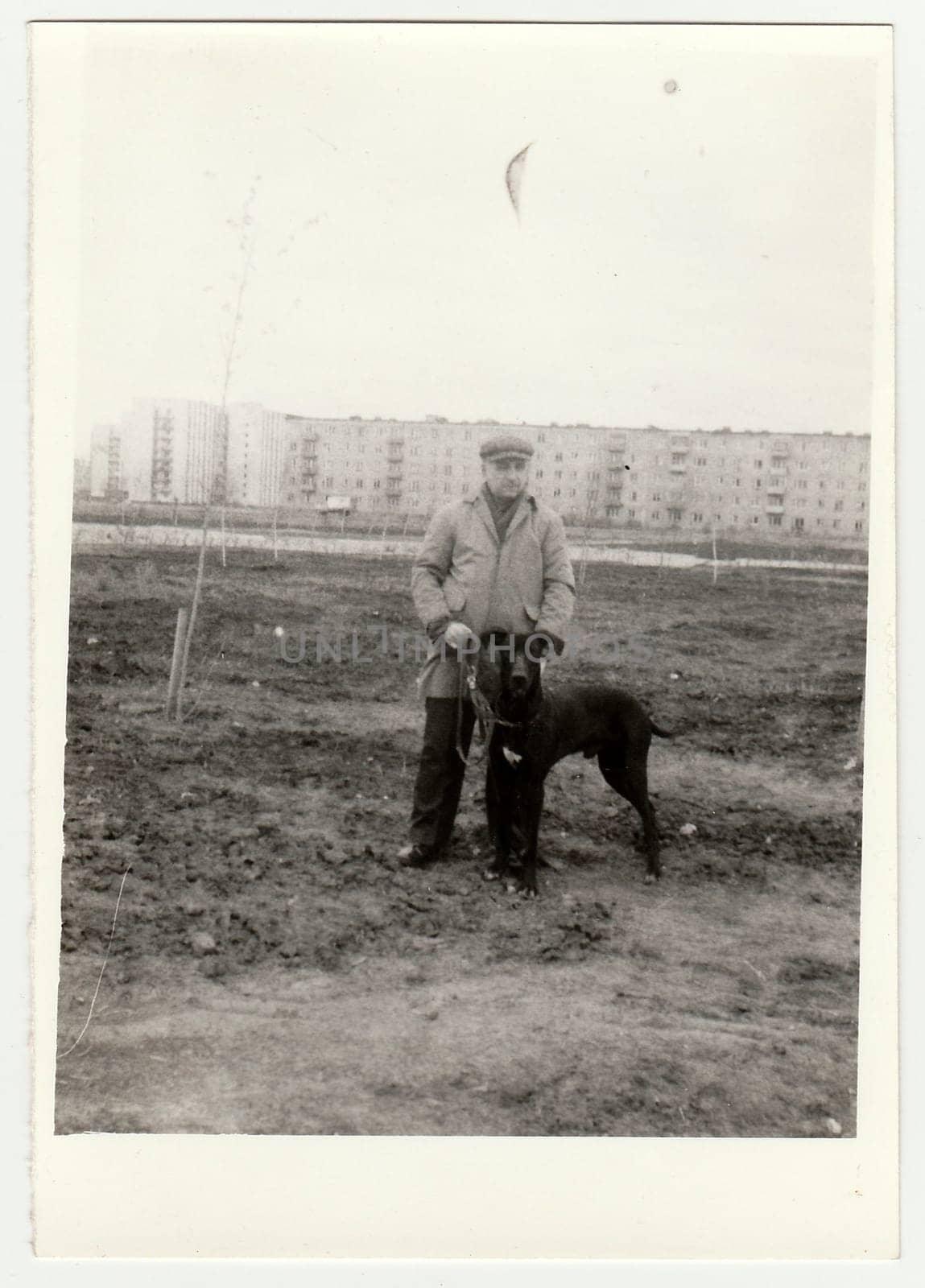 USSR - CIRCA 1970s: Vintage photo shows man walks the dog.