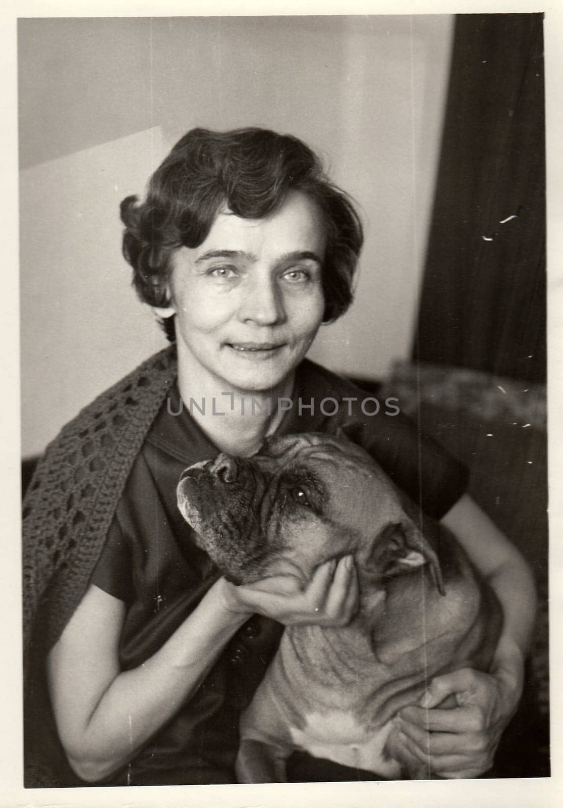 USSR - CIRCA 1980s: Vintage photo shows woman strokes dog.