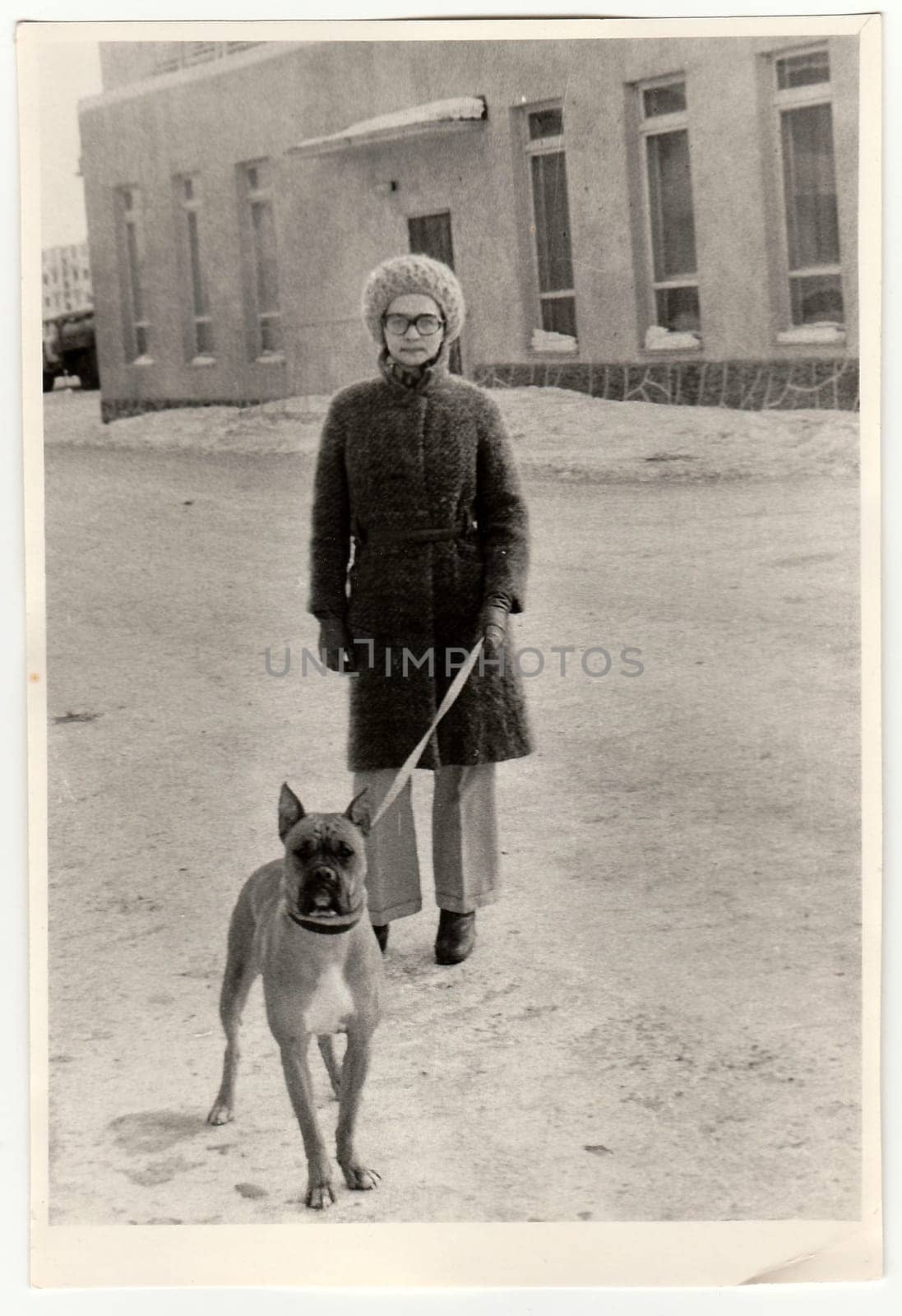 Vintage photo shows woman walks the dog. by roman_nerud