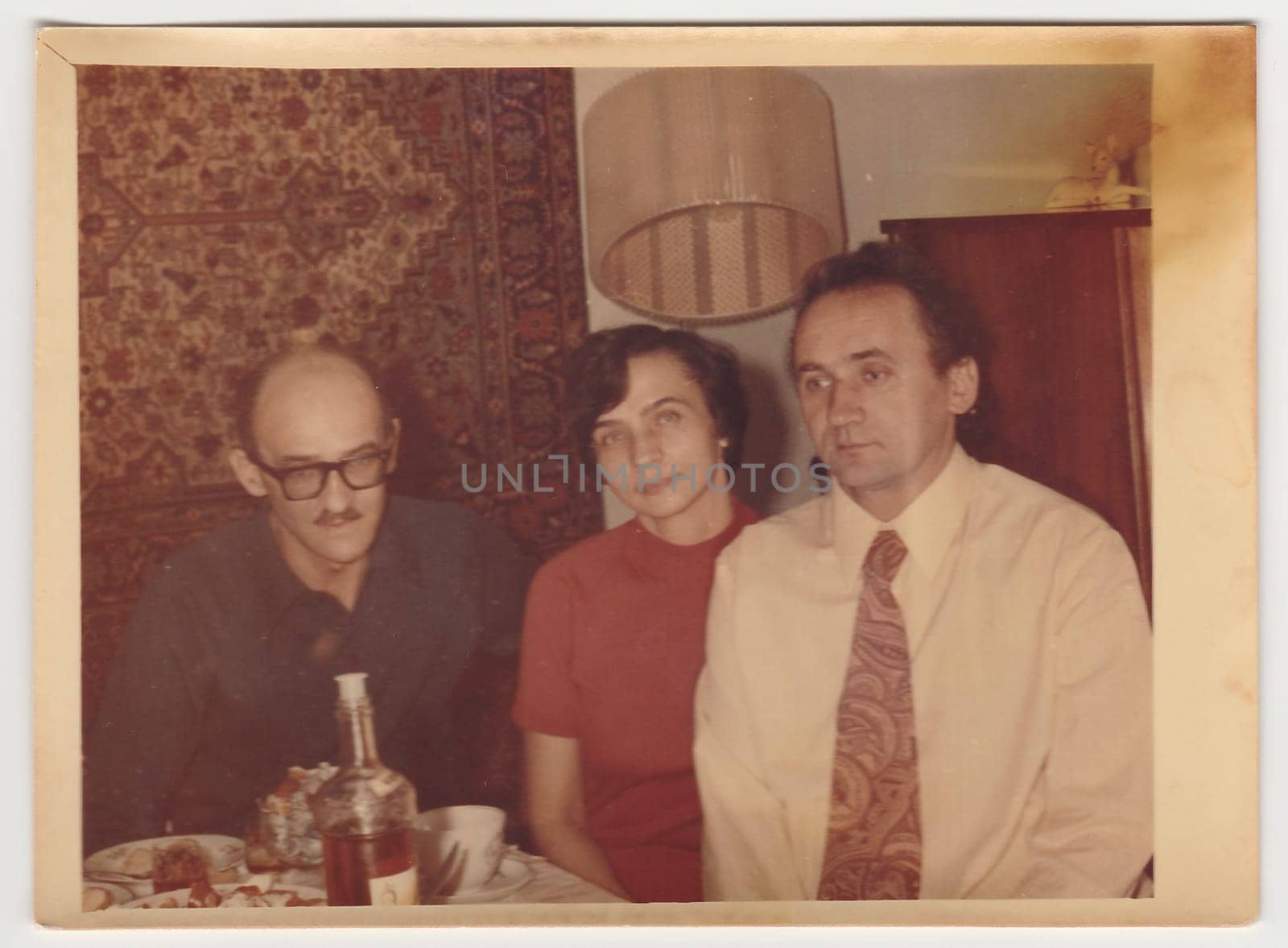 Vintage photo shows family during feast. by roman_nerud