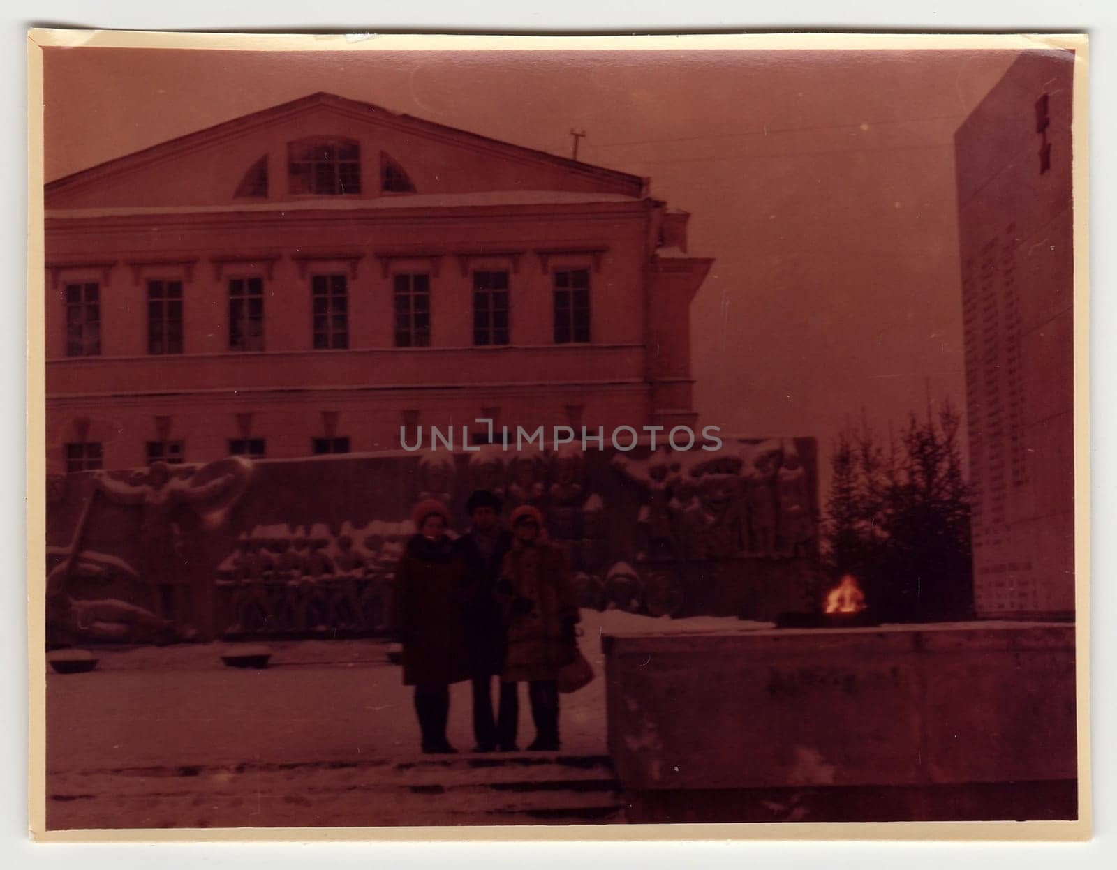 Vintage photo shows people pose on the street in winter. Photo is under exposed. by roman_nerud