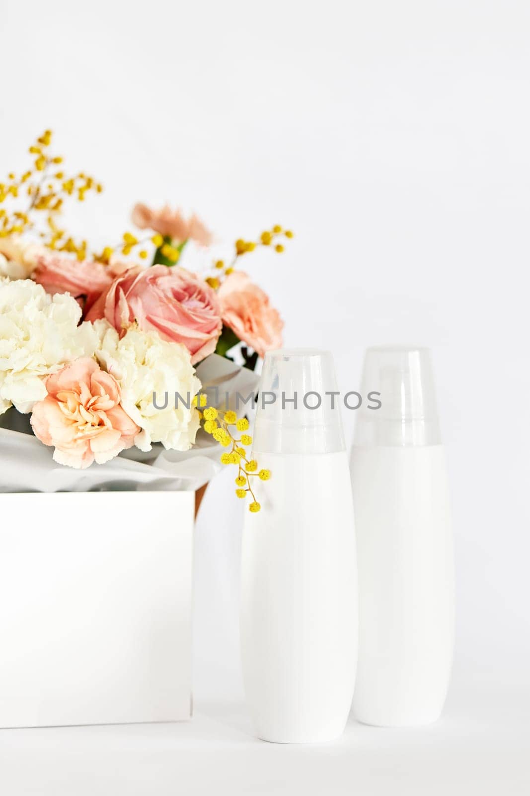 cosmetic beauty product bottle mockup with natural ingredient and spring flower. natural concept