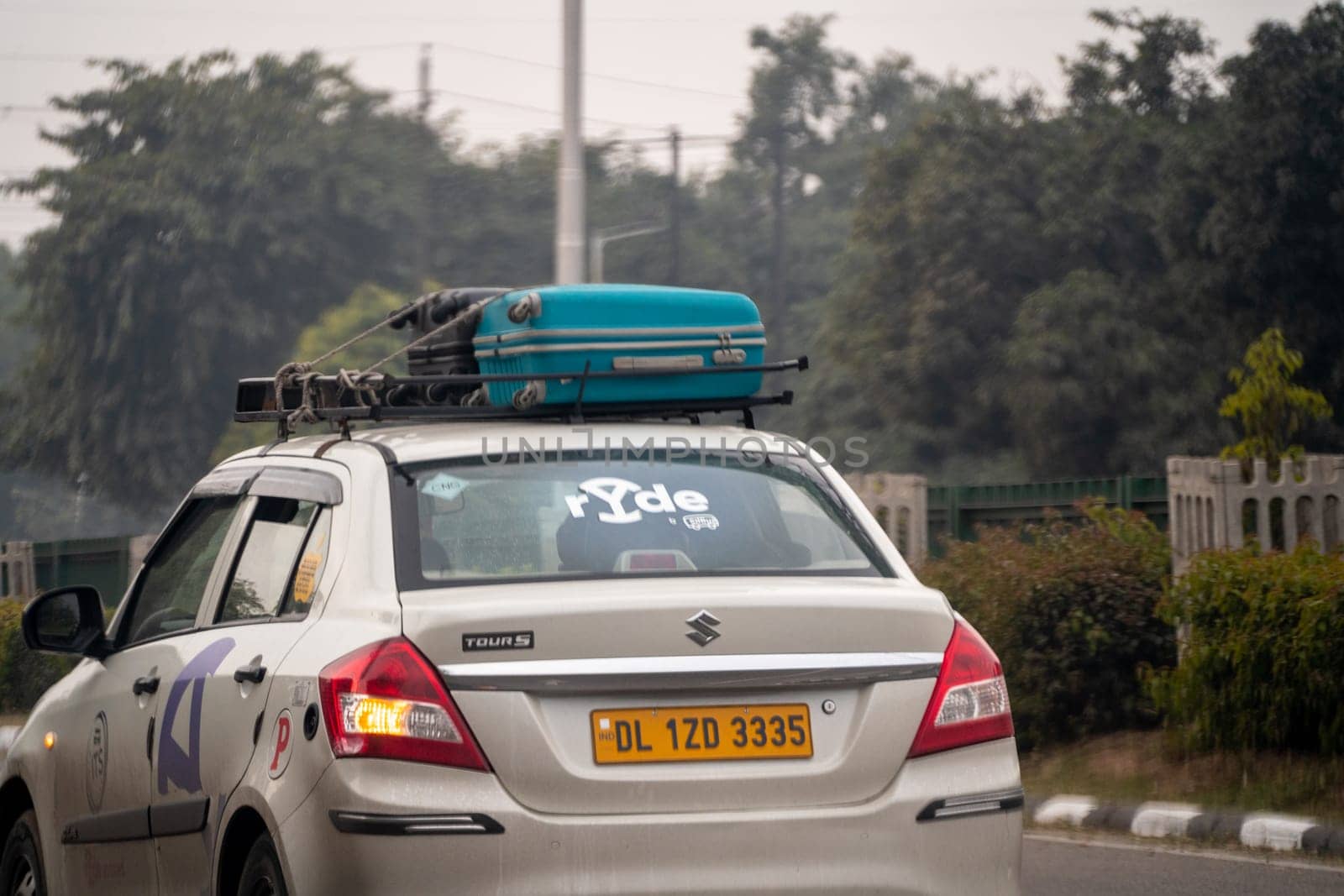 Chandigarh, India - circa 2023: Sedan car with sticker for Ryde by Redbus a taxi cab hailing startup for travelling intercity for business, vacation or fun