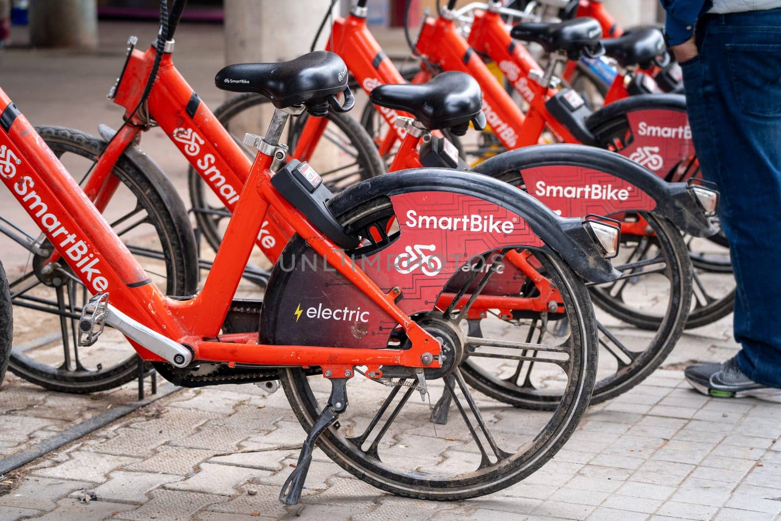 Chandigarh, Punjab, India - circa 2023 : cycle stand with red colored smart bikes standing for rent showing this internet mobility startup providing eco friendly cycles for hire