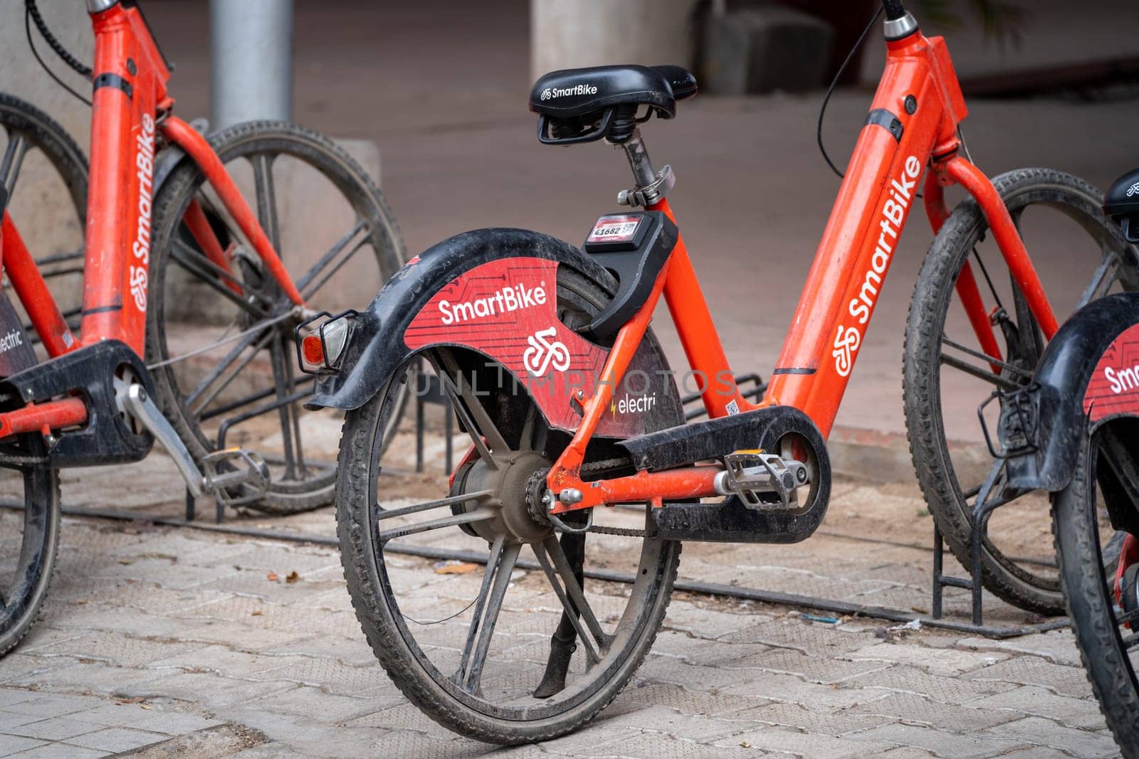 Chandigarh, Punjab, India - circa 2023 : cycle stand with red colored smart bikes standing for rent showing this internet mobility startup providing eco friendly cycles for hire