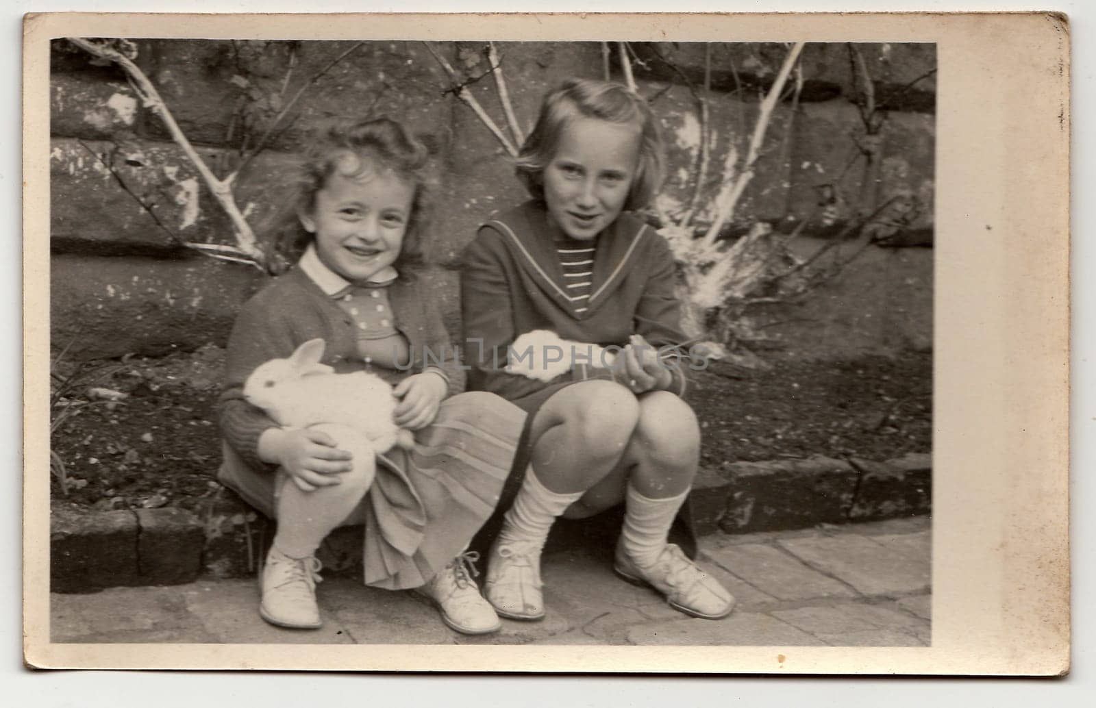 THE CZECHOSLOVAK SOCIALIST REPUBLIC - CIRCA 1960s: Vintage photo shows girls and rabbits during Easter.