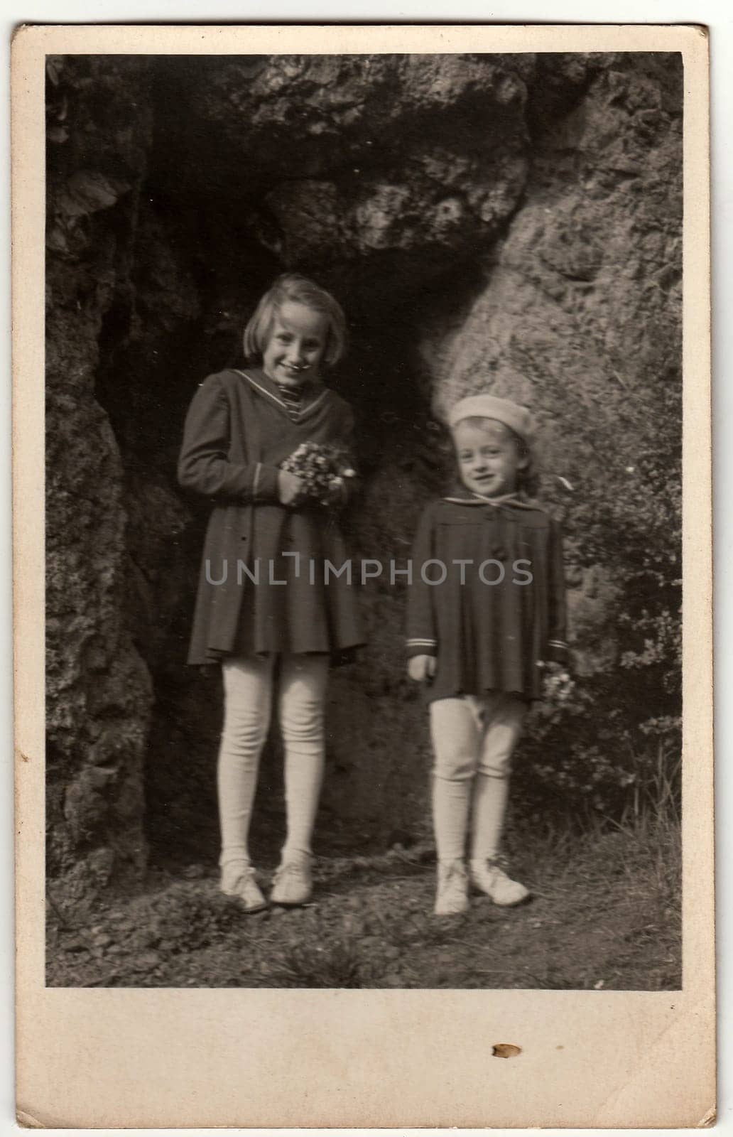 Vintage photo shows girls pose outdoors. by roman_nerud