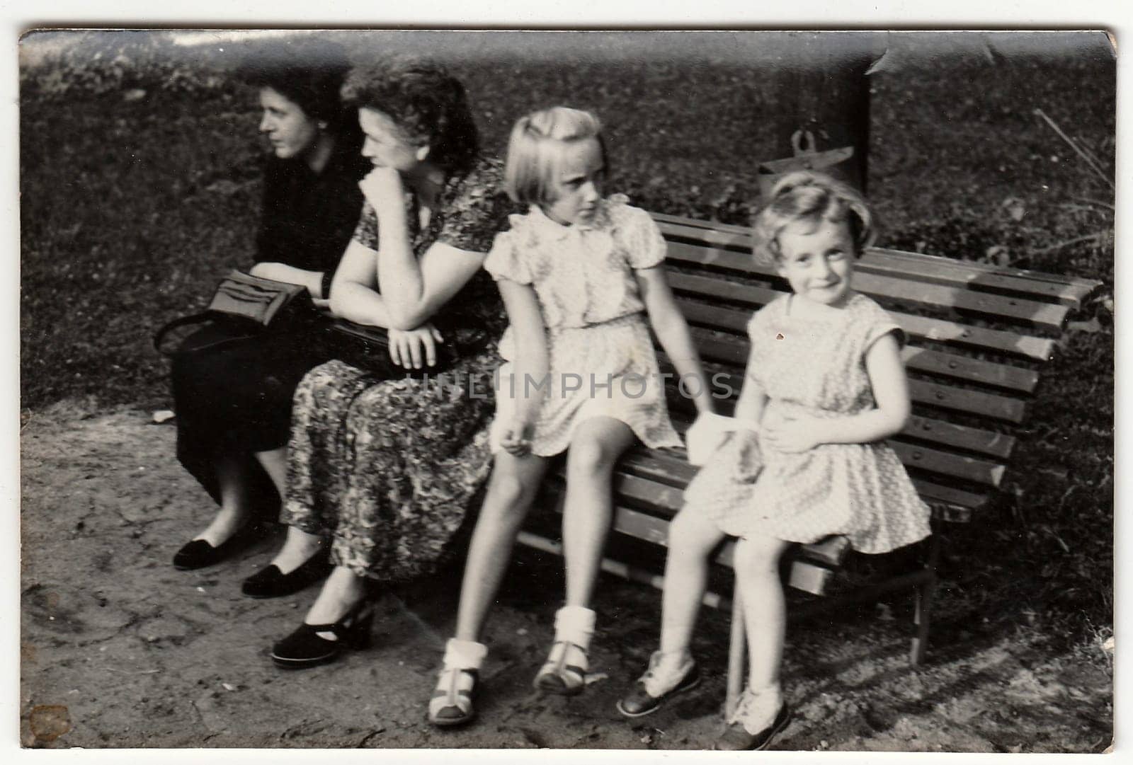 Vintage photo shows mothers and their daughters. Antique black & white photo. by roman_nerud