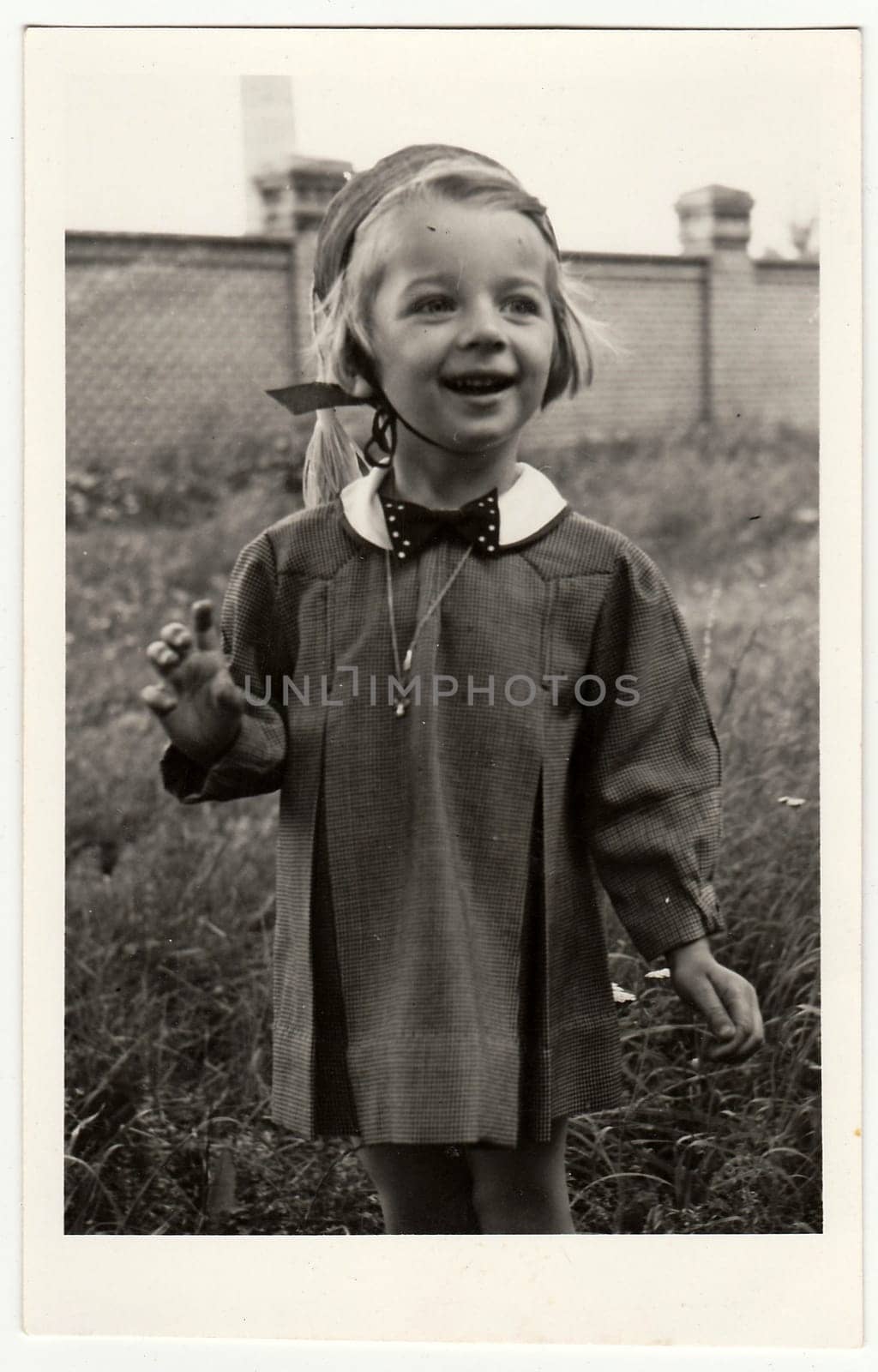 Retro photo shows a smiling girl. by roman_nerud