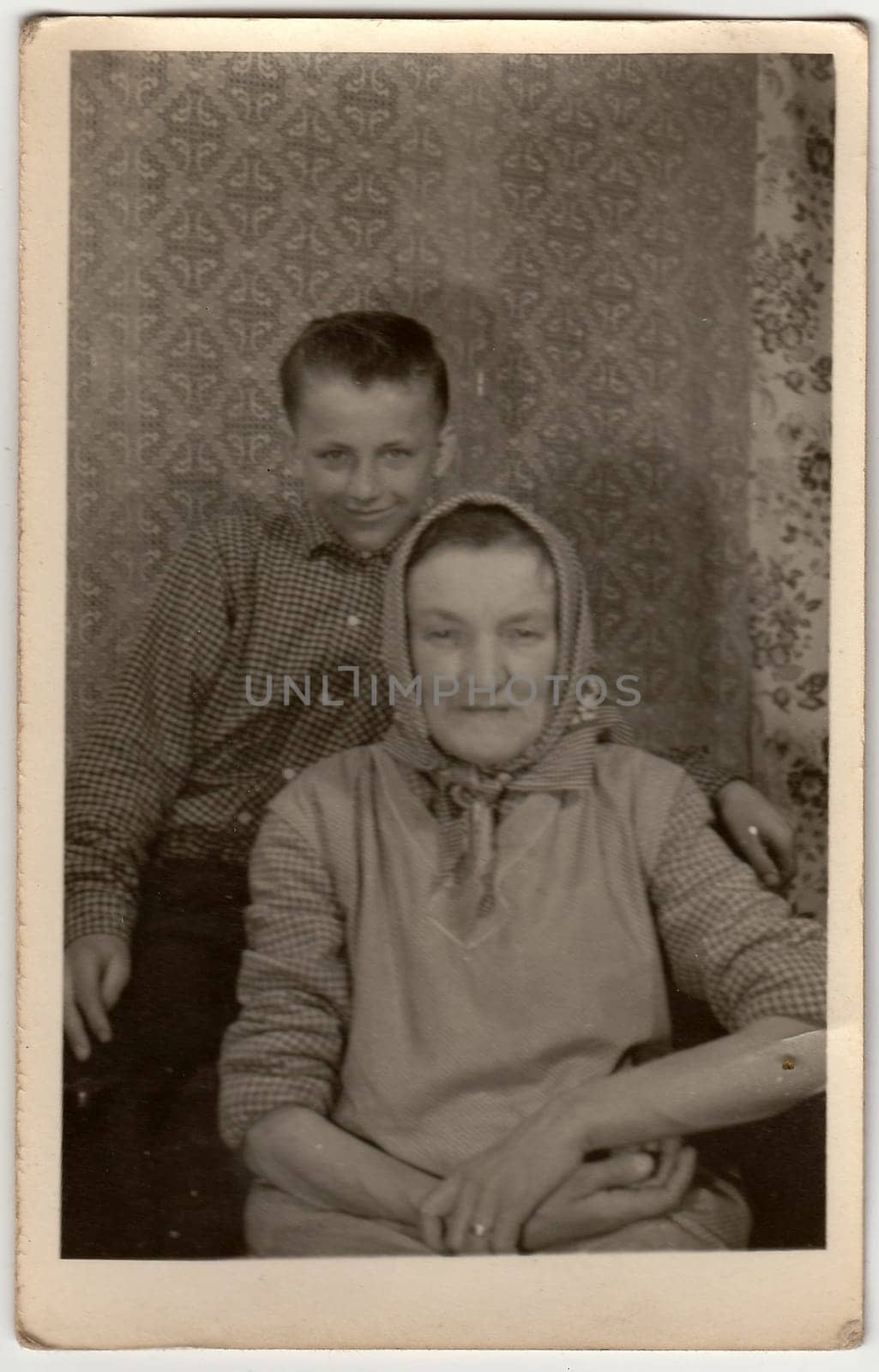 Vintage photo shows grandson with grandmother. by roman_nerud