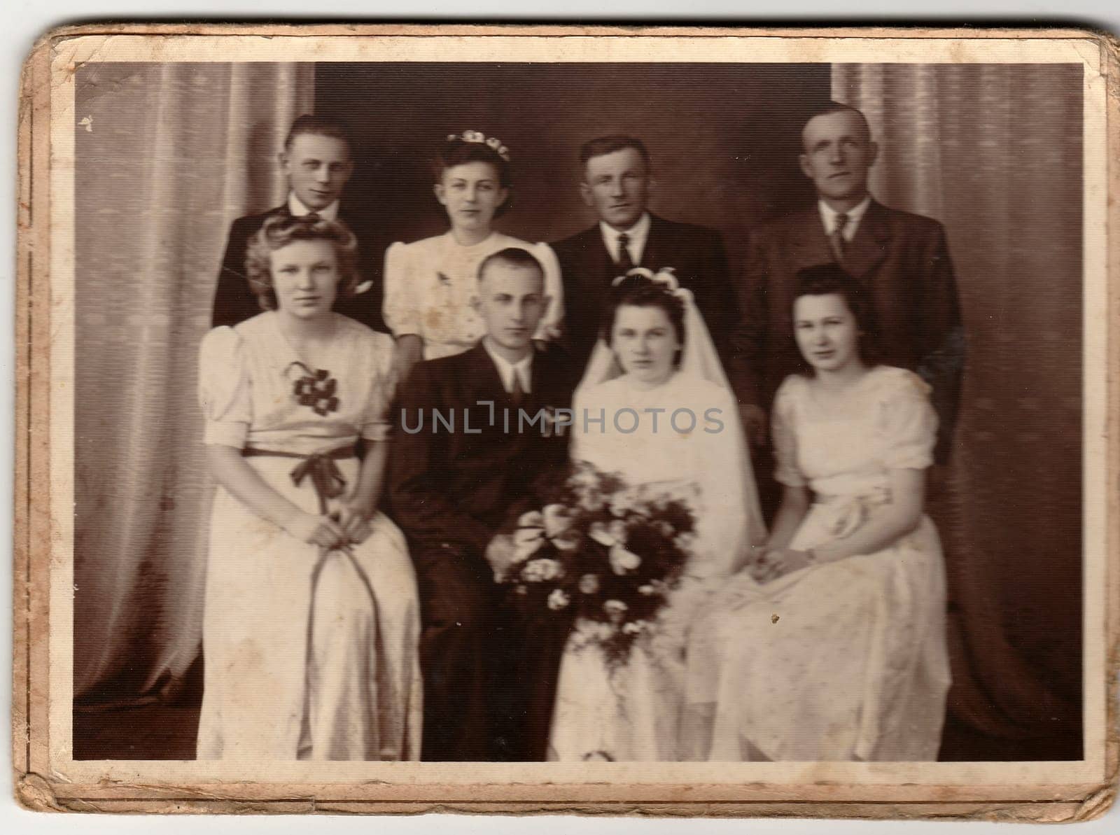 An antique Black & White photo shows newlyweds and wedding guests. by roman_nerud