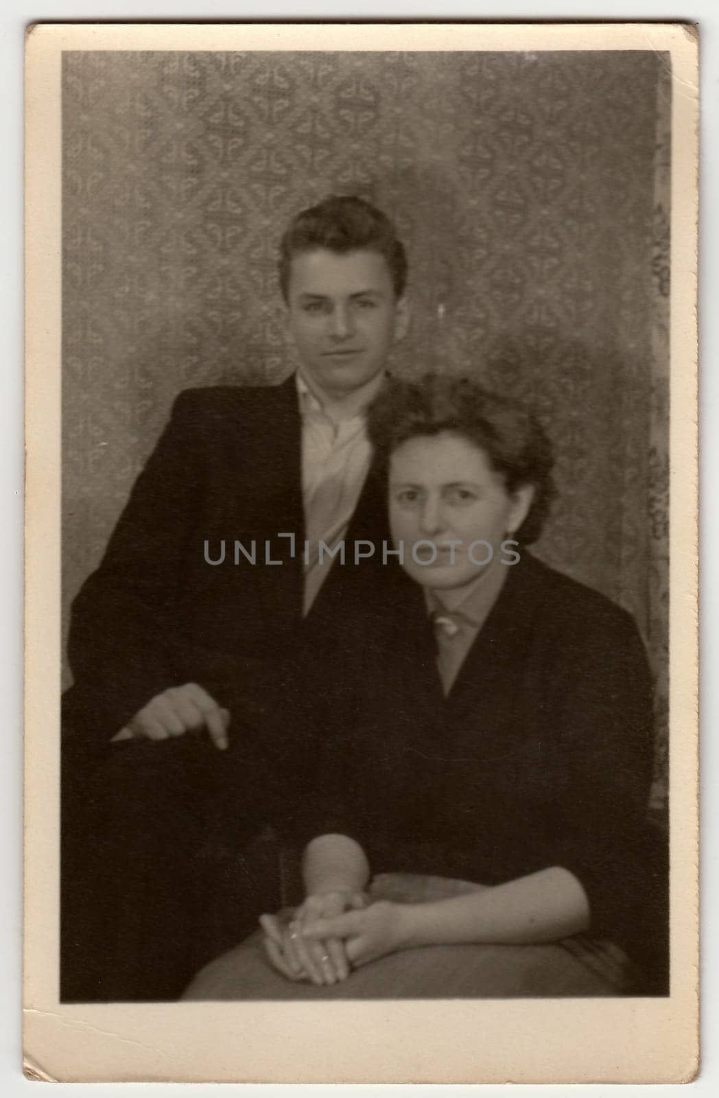 A vintage photo shows mother with adolescent son. by roman_nerud