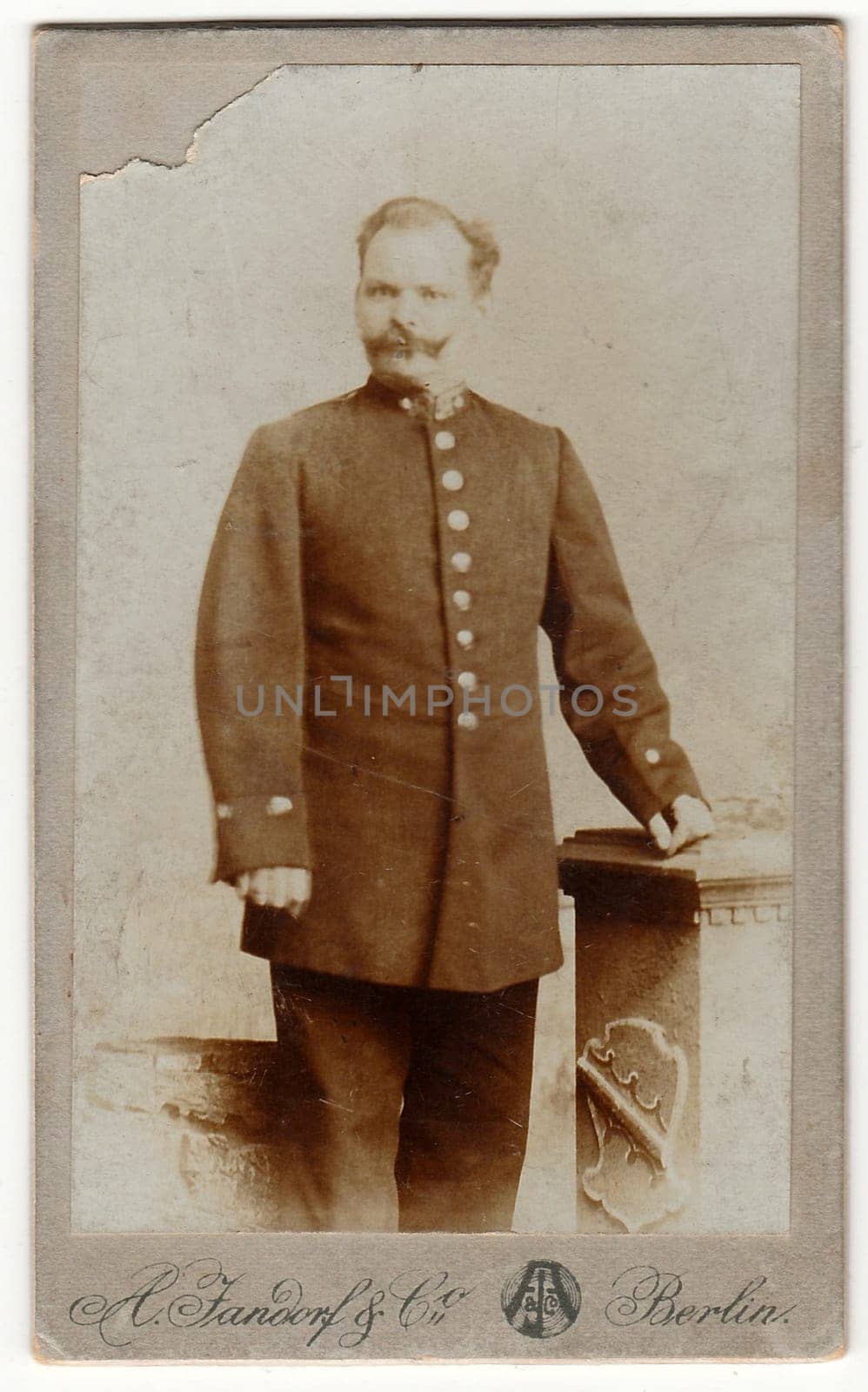 Vintage cabinet card shows man wears a postman uniform. Antique black white photo. by roman_nerud