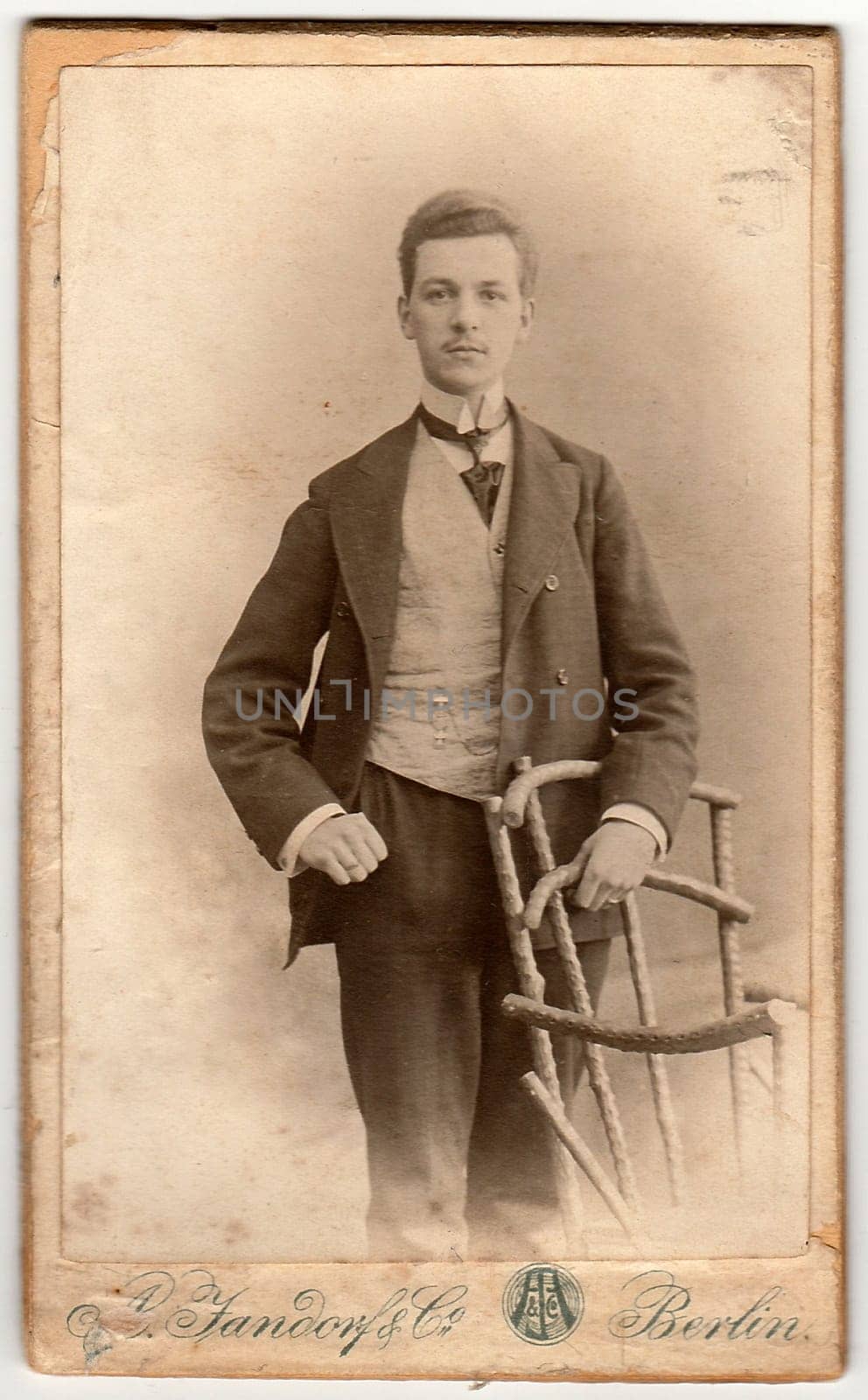 Vintage cabinet card shows dandy man wears posh garment. Antique black white photo. by roman_nerud