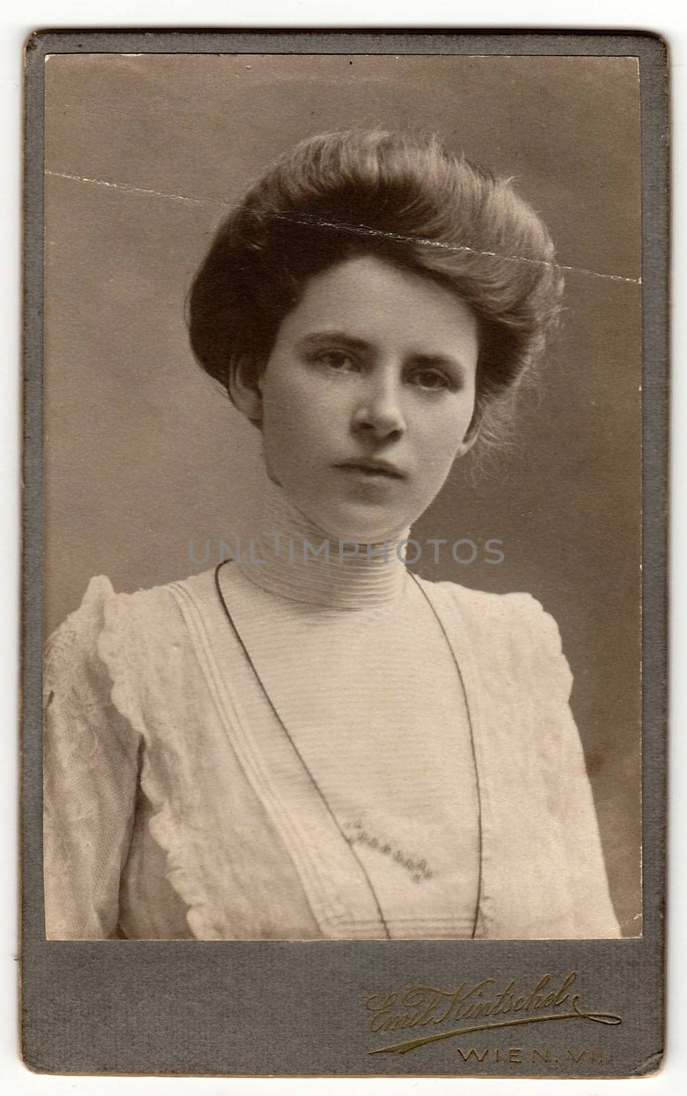 Vintage cabinet card shows woman with Victorian and Edwardian hair style. Antique black white photo. by roman_nerud