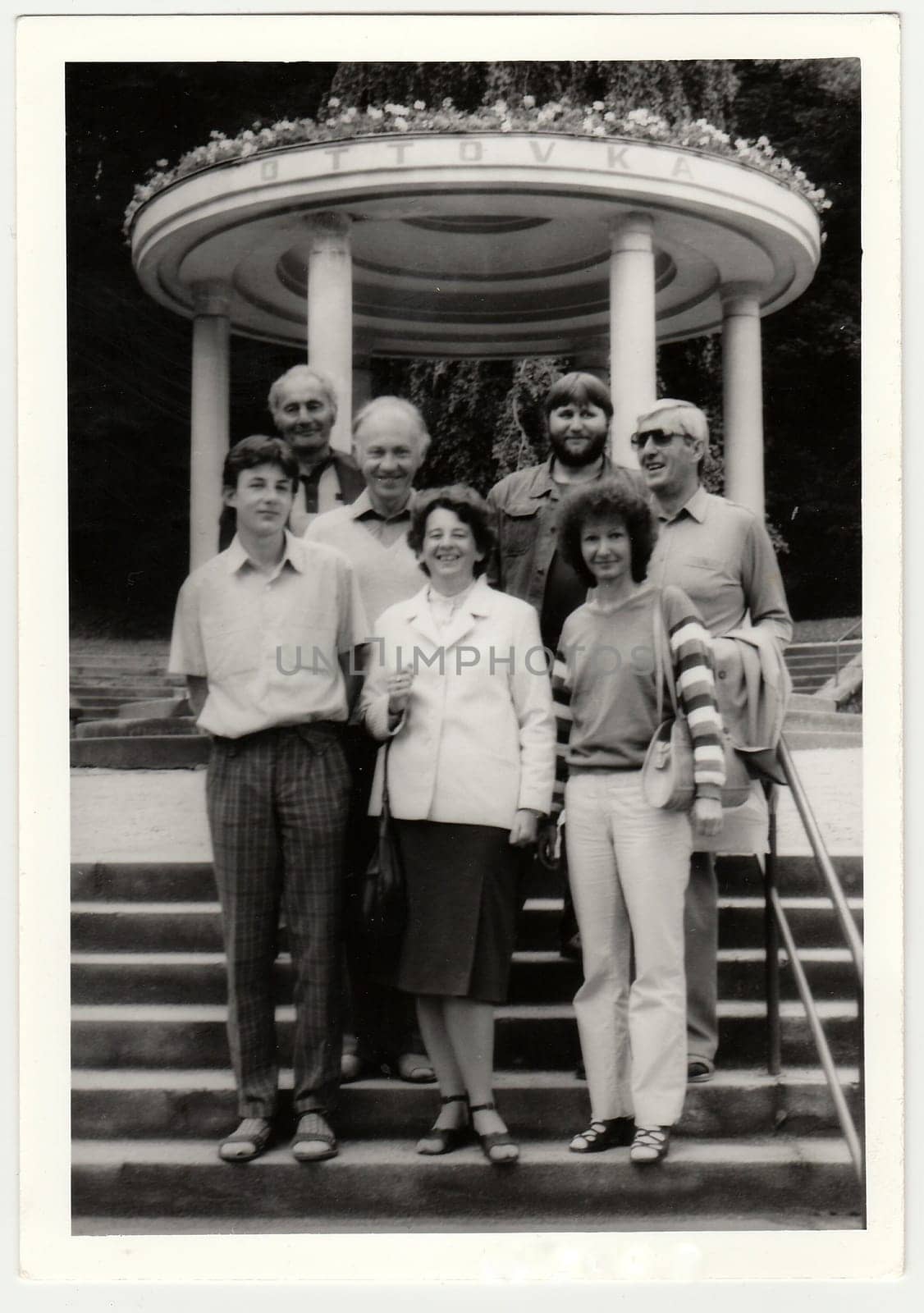 Vintage photo shows group of people at spa resort. by roman_nerud