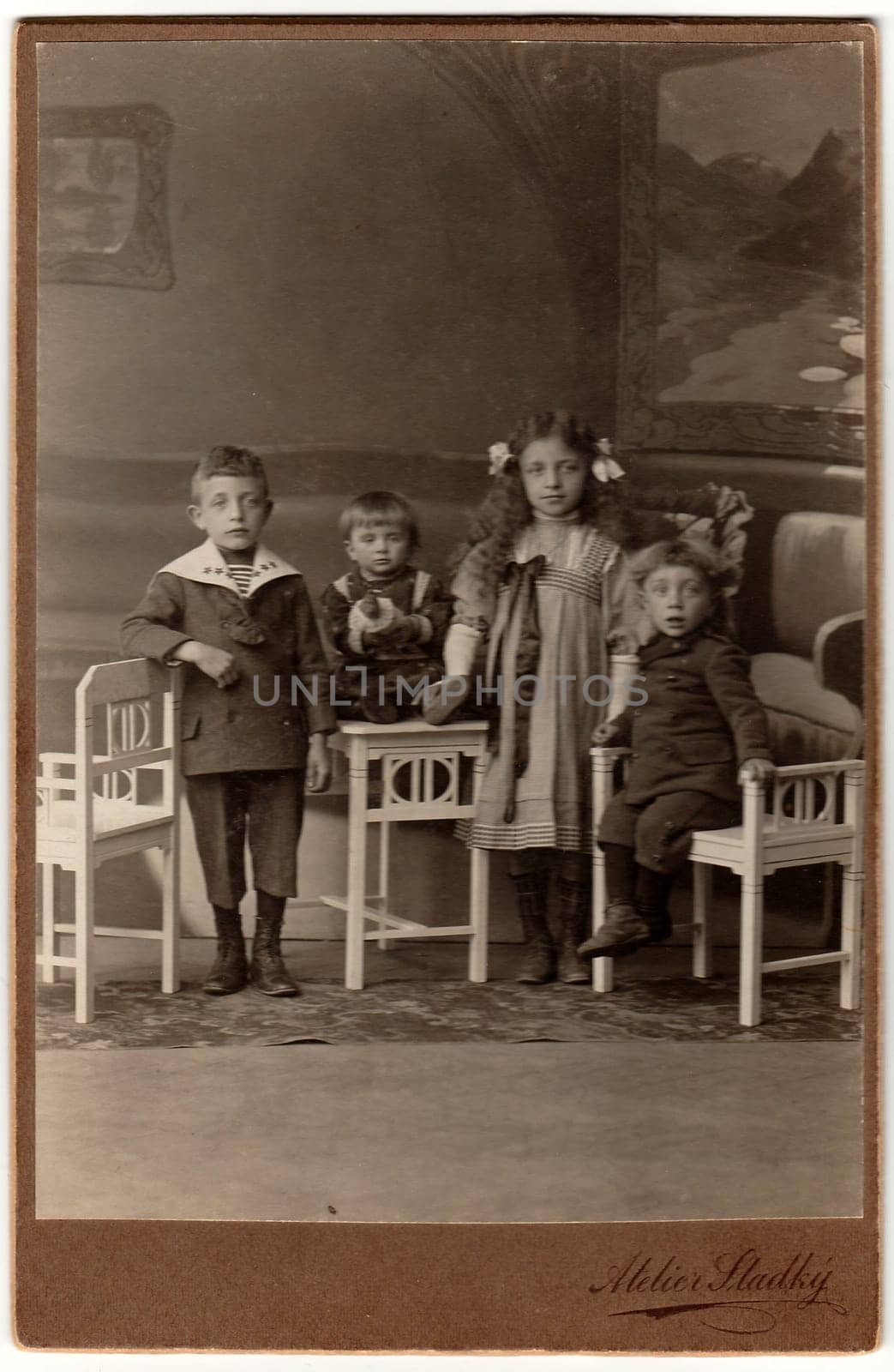 Vintage cabin card shows a group of children. Antique black white photo was taken in studio. by roman_nerud