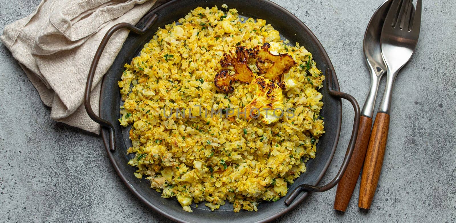 Fried cauliflower rice or couscous with dill on plate, healthy low carbohydrates vegetable side dish for keto diet and healthy low calories nutrition, rustic stone background by its_al_dente