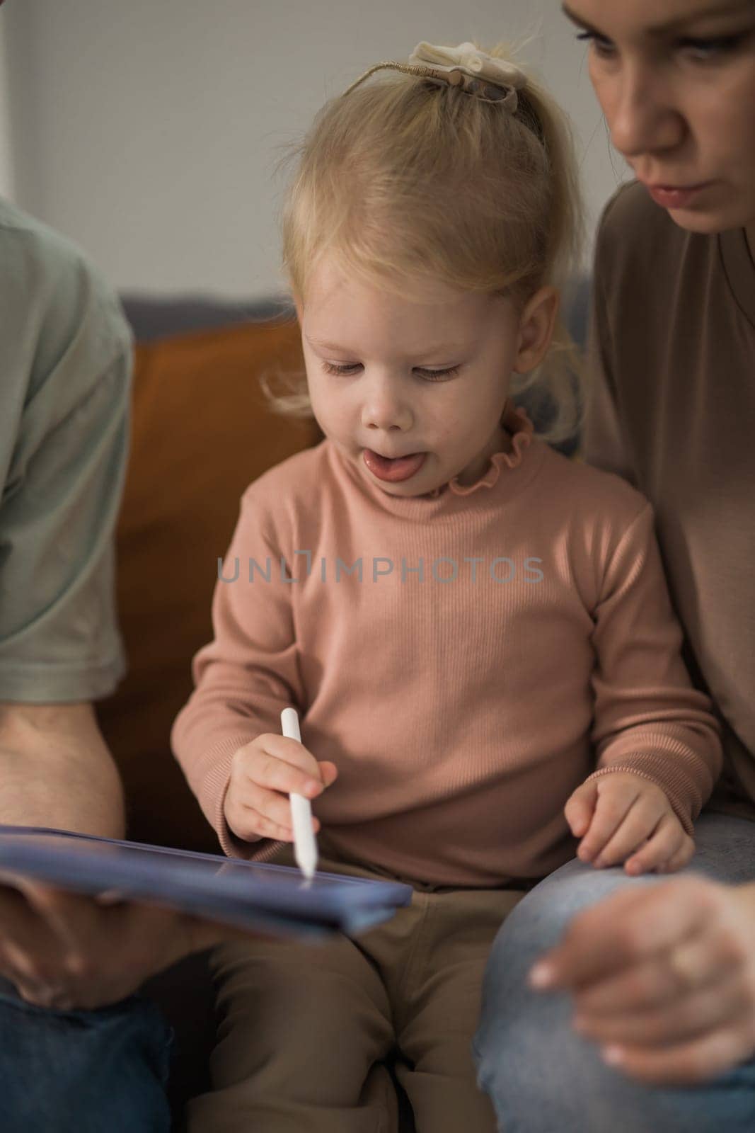 Deaf child girl with cochlear implant studying to hear sounds - recovery after cochlear Implant surgery and rehabilitation