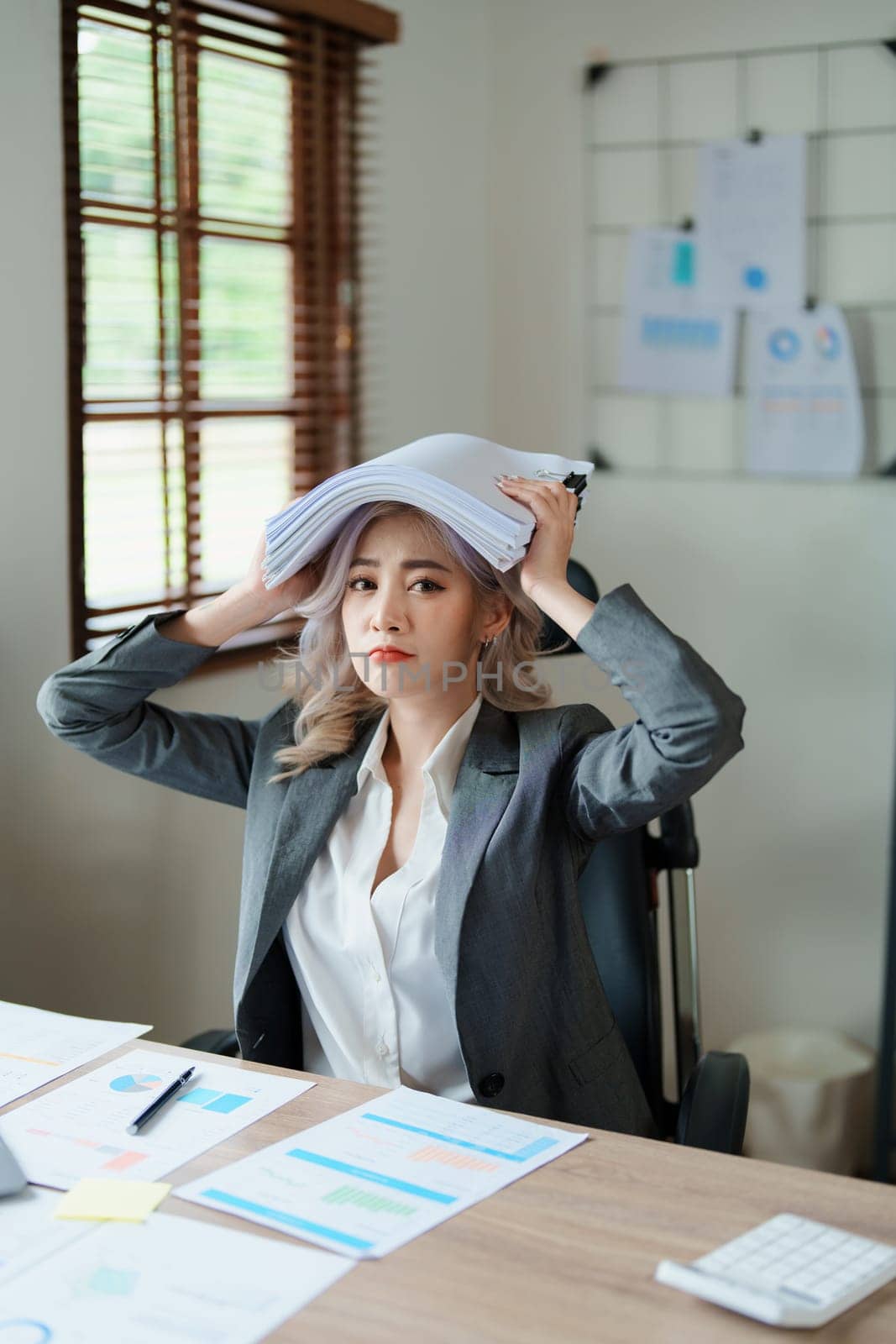 Portrait of sme business owner, woman using computer and financial statements Anxious expression on expanding the market to increase the ability to invest in business.