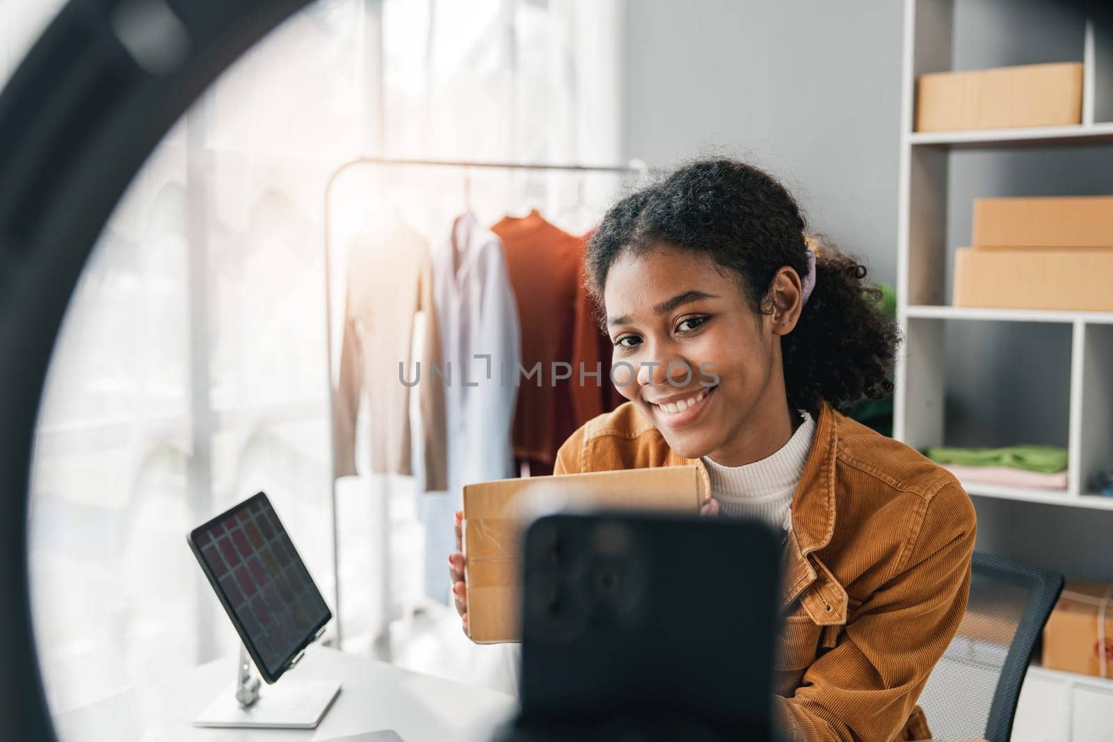 Female stylist Successful Fashion Business.Portrait of Smiling Black woman designer stylish stand and working with color samples. by wichayada